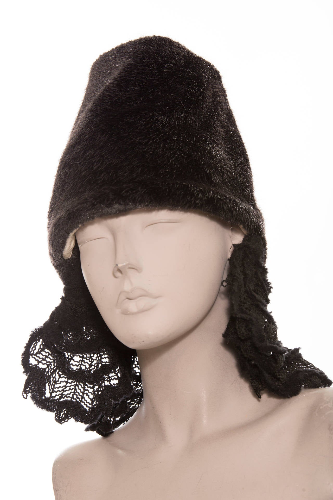 Comme des Garçons black faux fur hat with open top and hanging crochet accent at trim.

Circumference: 23 inch