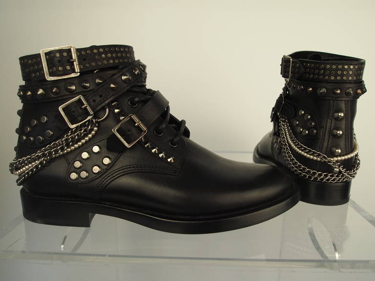 Saint Laurent Ranger Boots, black studded leather, metal and faux pearl chains, adjustable straps, leather lining and soles.