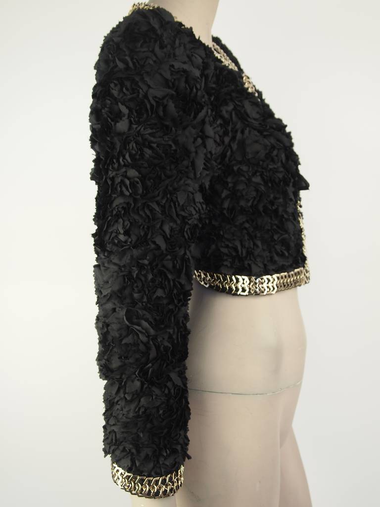 Givenchy black silk ruffled cropped jacket, gold-tone chain trim, hook & eye closure and fully lined.