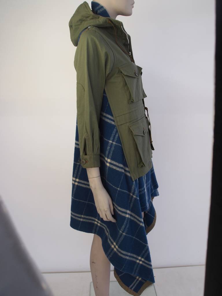 Comme des Garcon, army green, cotton, hooded coat, front zip closure and button closure with blue flannel inset with shoulder cutouts.