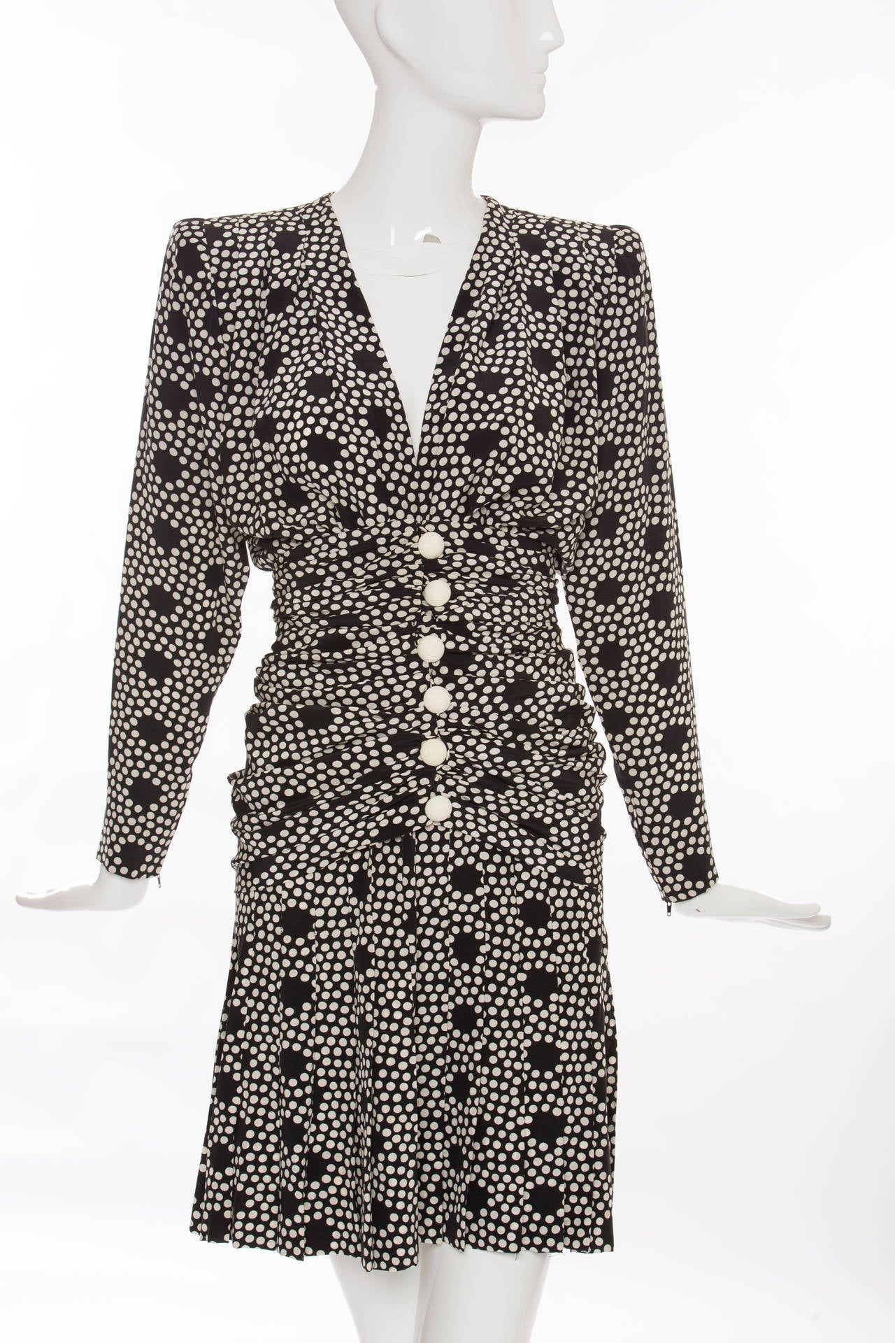 Givenchy Haute Couture, circa 1980s skirt suit. The top has several hidden hook and eye and snap closures, cream button front with self belt. The drop pleated skirt has side zip and hook and eye closure.

Top: Bust 39, Waist 22, Waist 29, Length