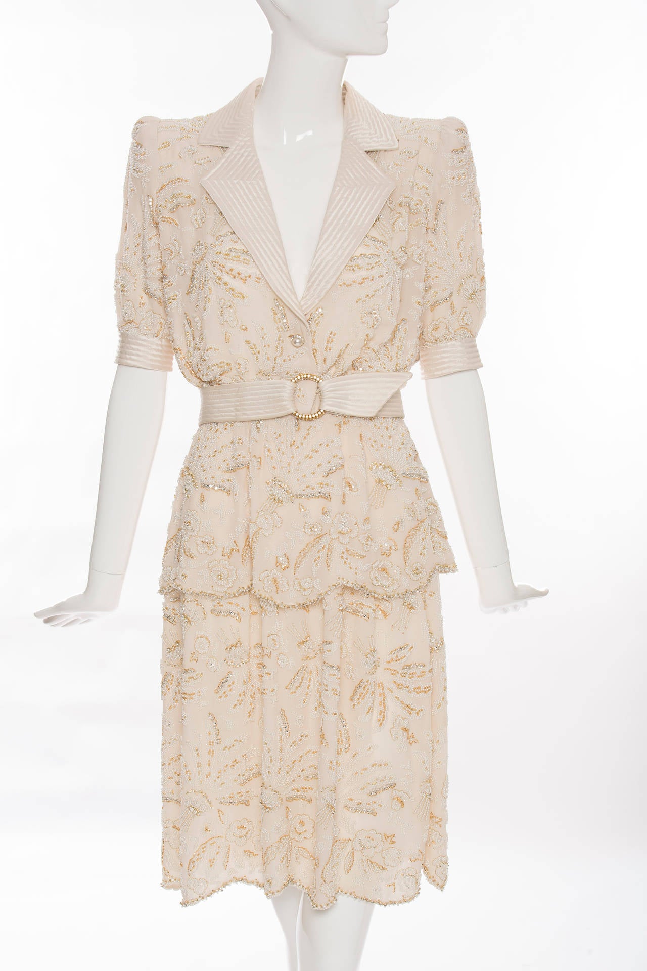Valentino Haute Couture, Circa 1980's, cream silk chiffon skirt suit with seed pearl embroidery, quilted silk satin trim and self belt, side zip, and fully lined.

Jacket: Bust, 36, Waist 24 Length 26.5

Skirt:  Waist 23, Hips 48;  Length 24