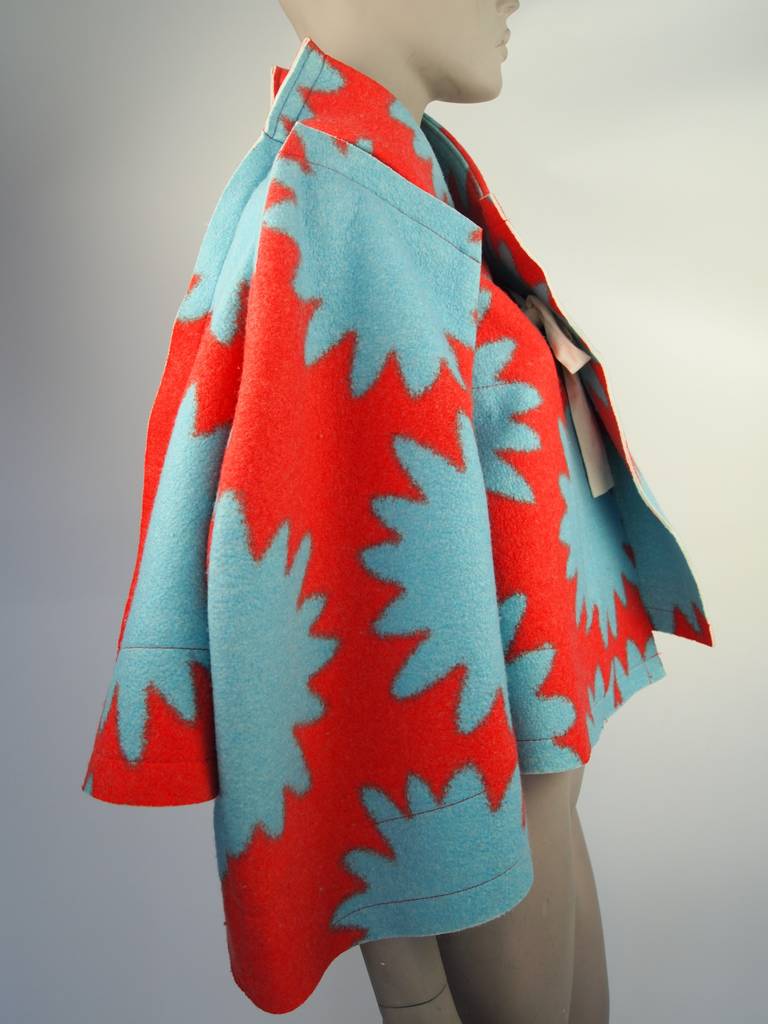 Comme des Garcons, Fall 2012, graphic turquoise and red, tie front jacket.