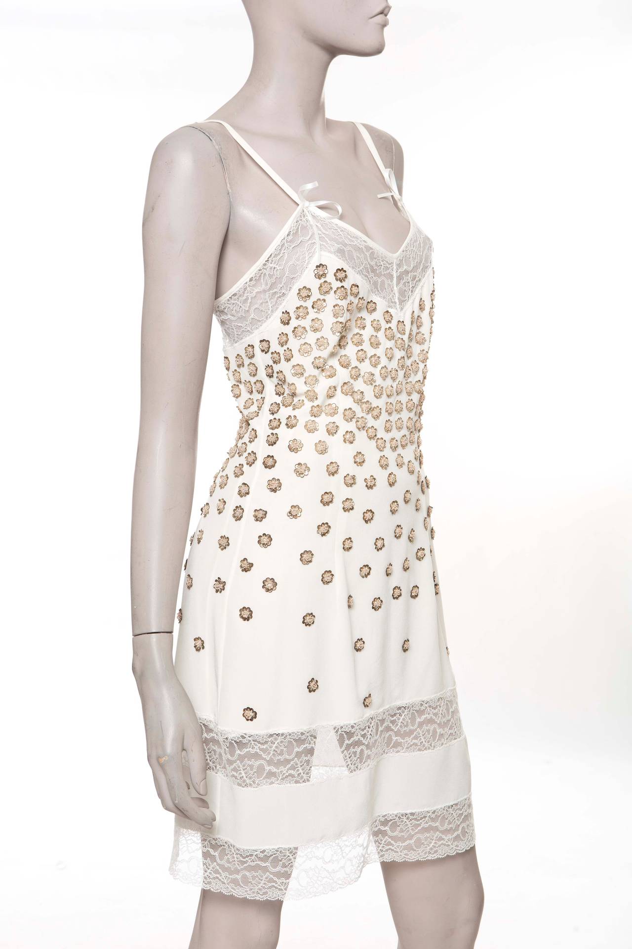 John Galliano for  Christian Dior, silk sleeveless slip dress with V-neck, lace trim, floral sequin appliqués throughout and side French button closures.

Measurements: Bust 32”, Waist 28”, Hip 34”, Length 38”
Fabric Content: 100% Silk; Lace: