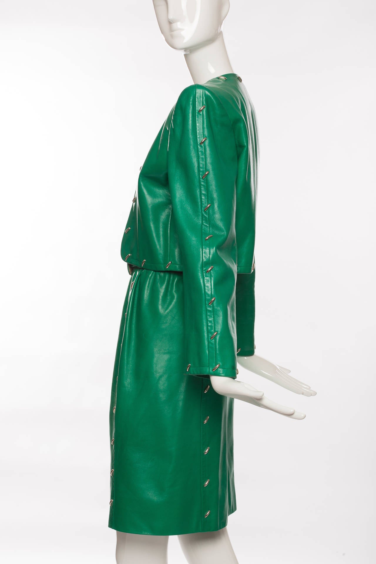 Givenchy Couture, Circa 1980's leather skirt suit with silver stud embellishment, fully lined in silk and skirt has side zip closure and self belt.