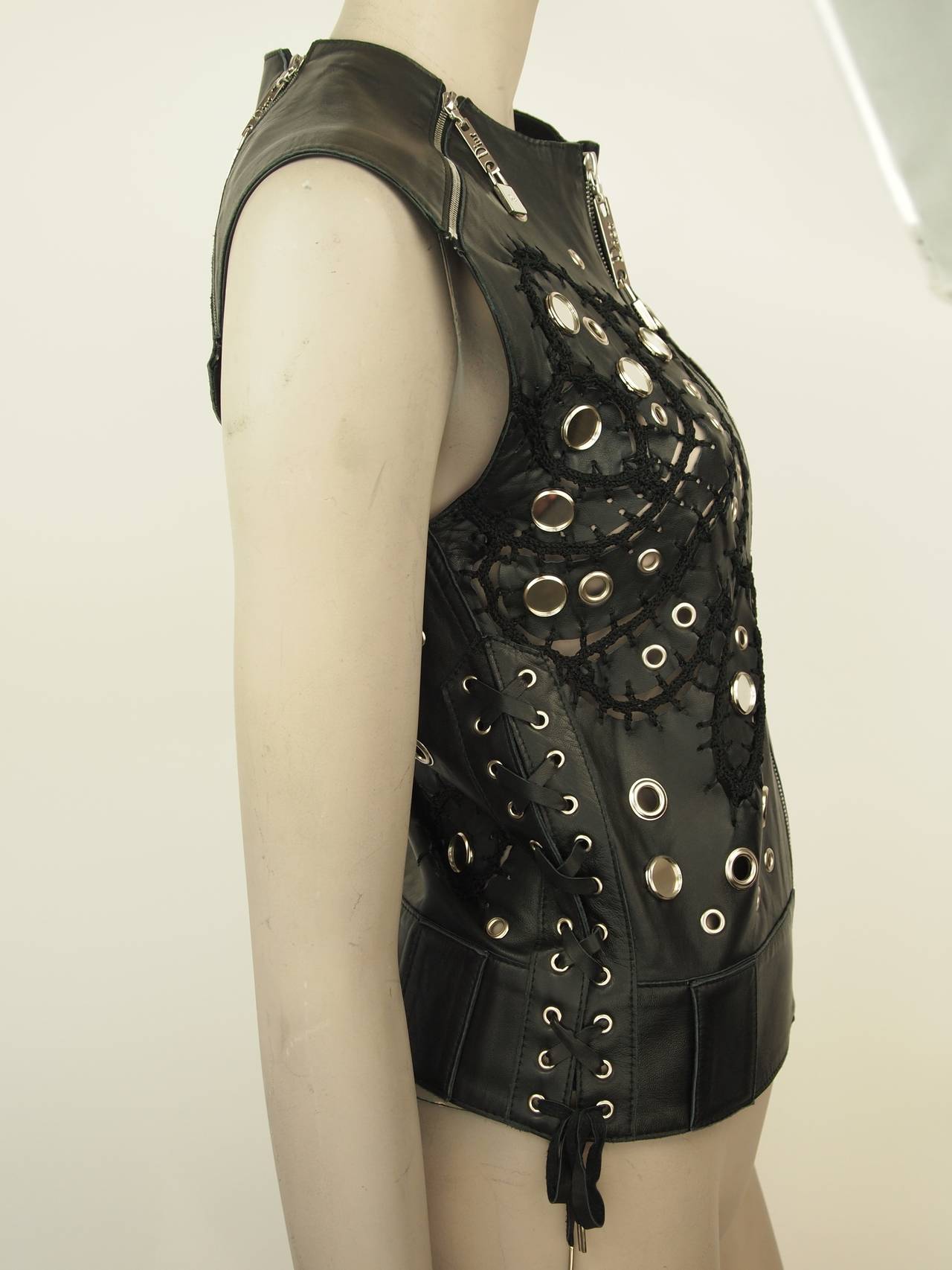 Christian Dior black leather vest with silver-tone hardware, mirror studs, knit seams and front zip closure.
