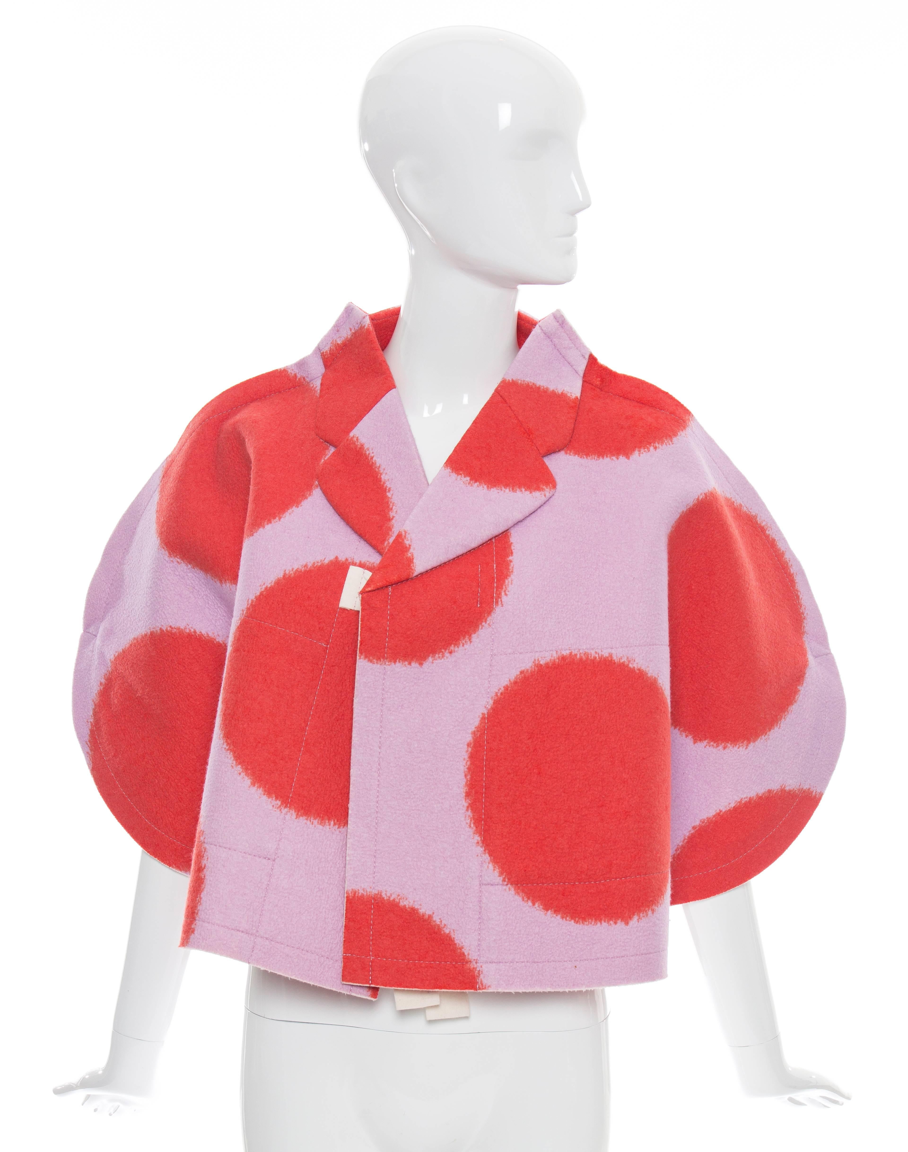  Comme des Garçons, Autumn-Winter 2012, wool polka dot felt cape with notched collar, dual internal pockets and front tie closure.

Japan: Small

Length 20”

Fabric Content: 60% Wool, 40% Rayon; Lining: 100% Polyester