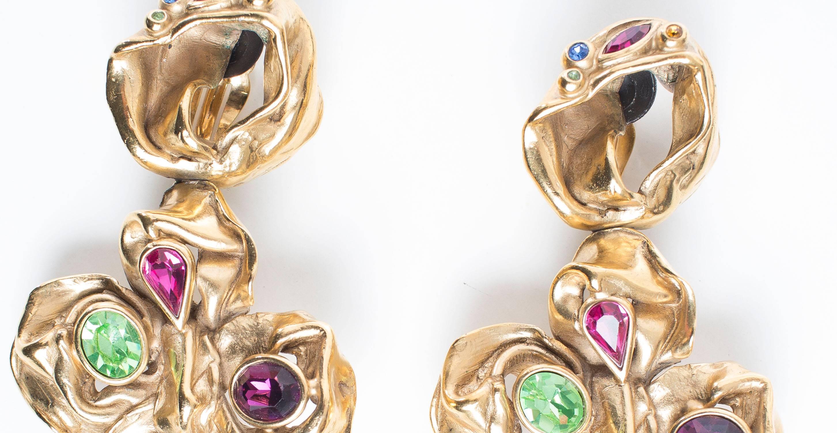 Yves Saint Laurent, circa 1980's, massive gilt leaf, clip-on earring with multi-colored faceted stones and created in the ateliers of French parurier Robert Goossens.