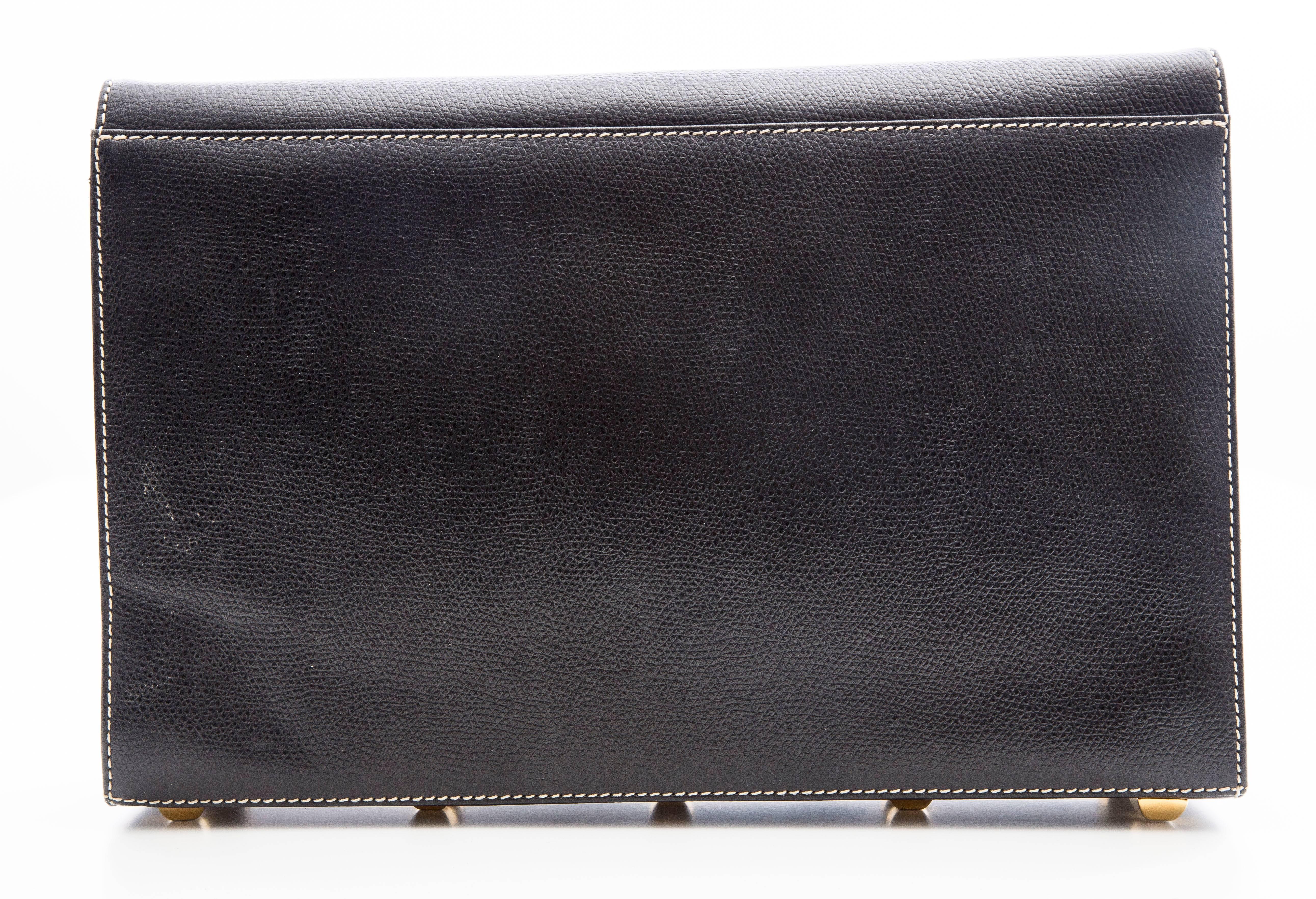 Salvatore Ferragamo, circa 1980's, black luxe grain clutch, interior zip pocket, studded bottom and removable strap.
