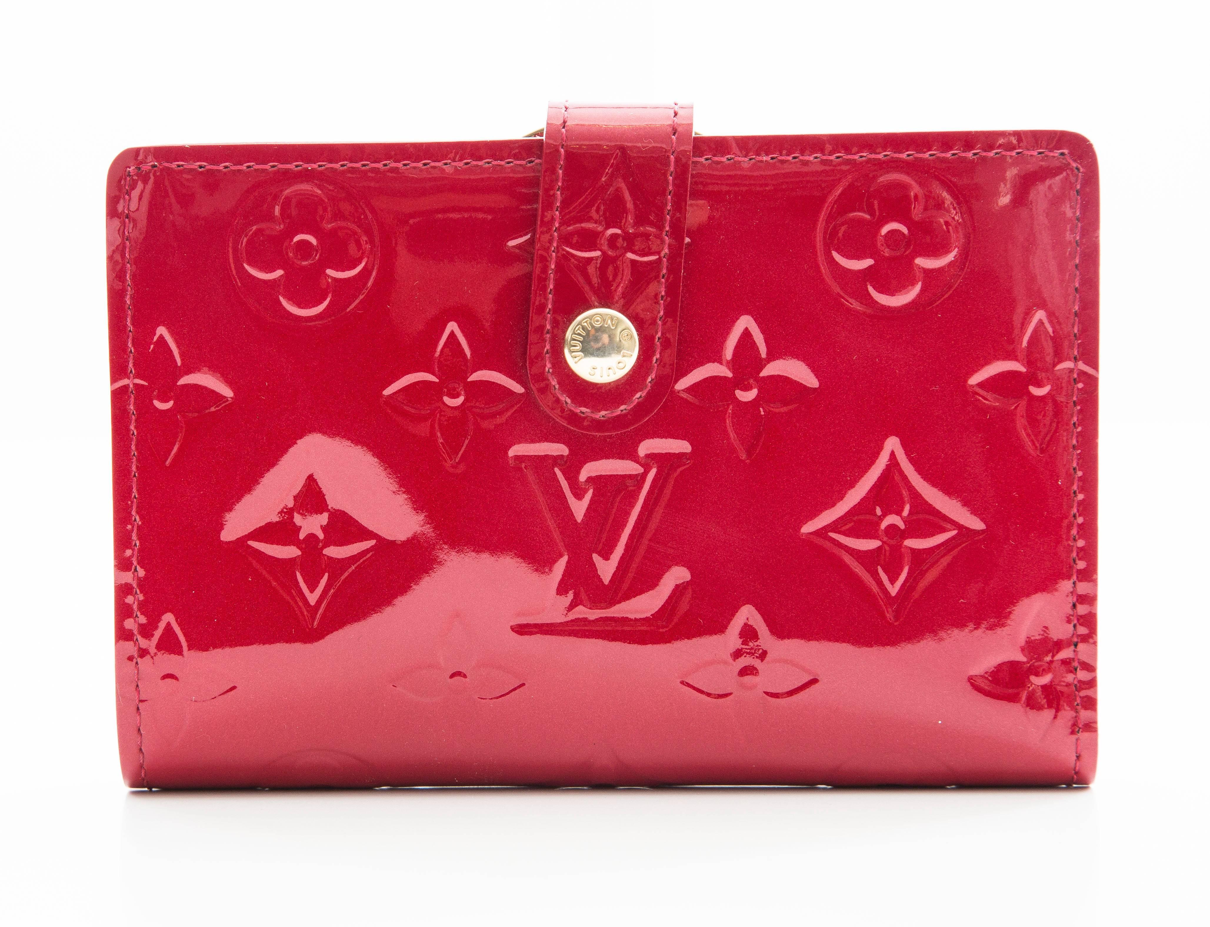 Cherry red monogram vernis Louis Vuitton French purse wallet with brass hardware, eight interior card slots, one bill compartment, snap coin pocket and front snap closure.

 Height 3.5”, Width 5”, Depth 1”