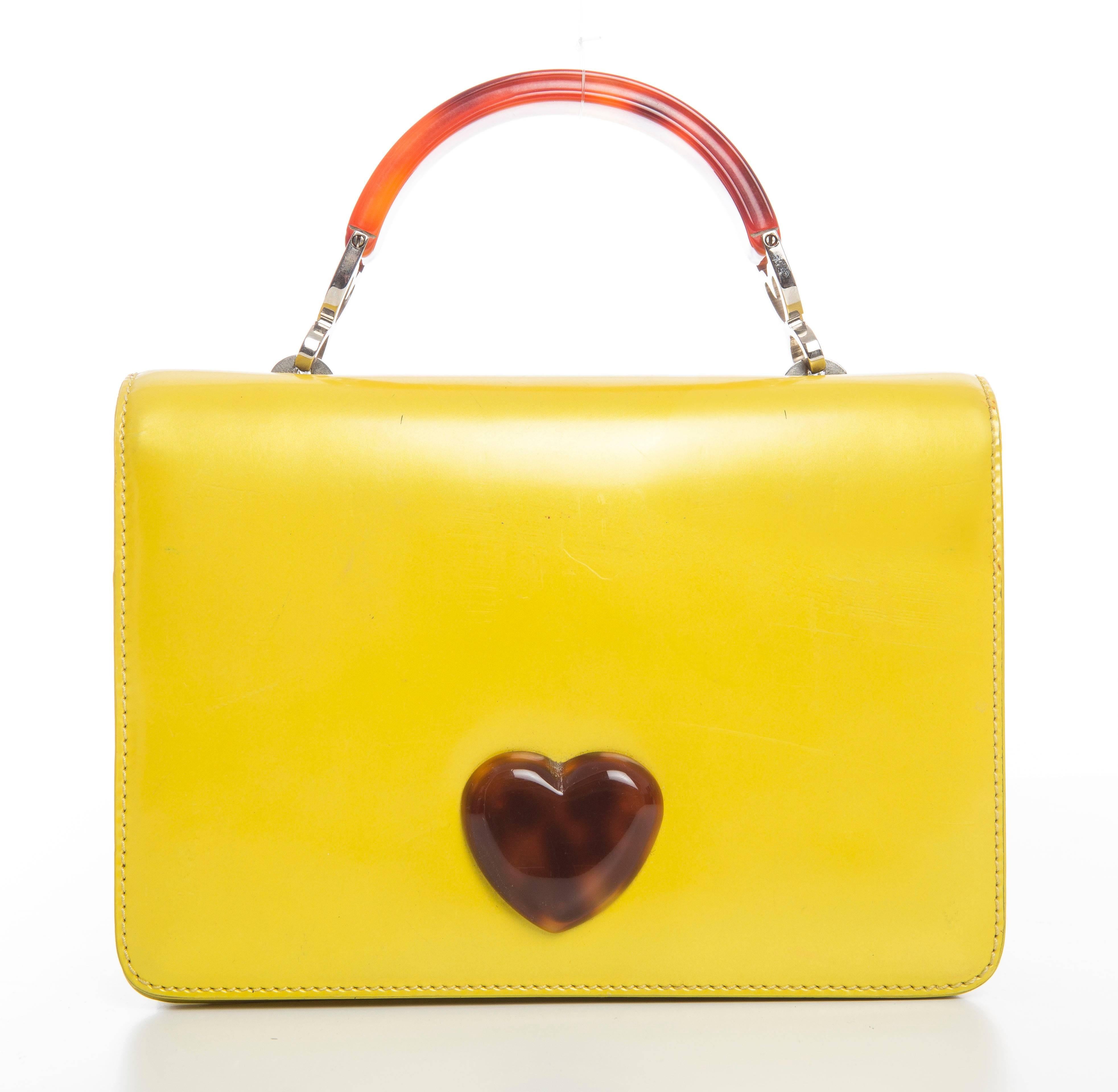 Moschino, circa 1990's yellow leather handbag with embellished heart and one interior pocket.