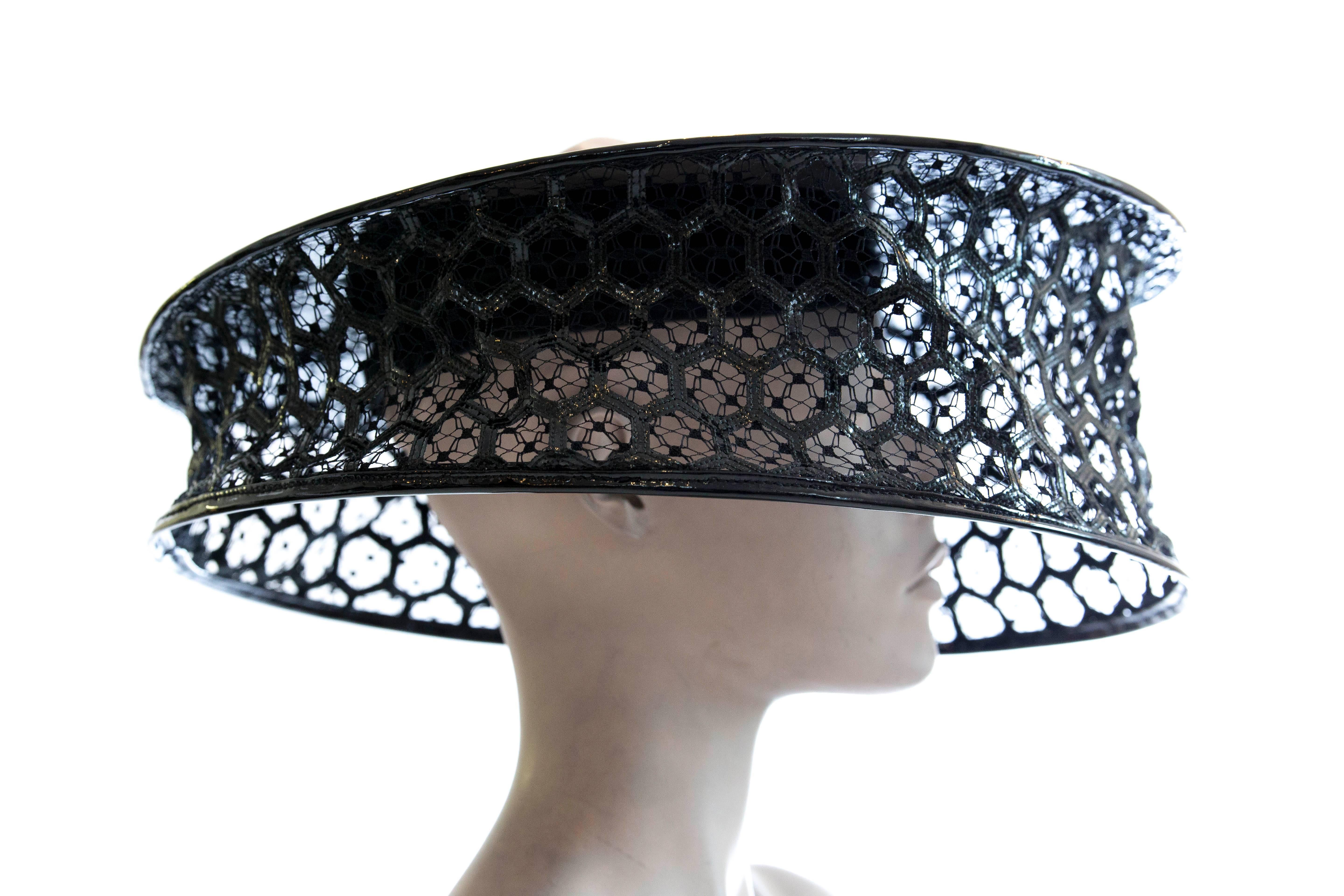 Alexander McQueen, Spring 2013, collapsible black patent leather Honeycomb hat with topless feature and tonal stitching throughout.

Circumference 14