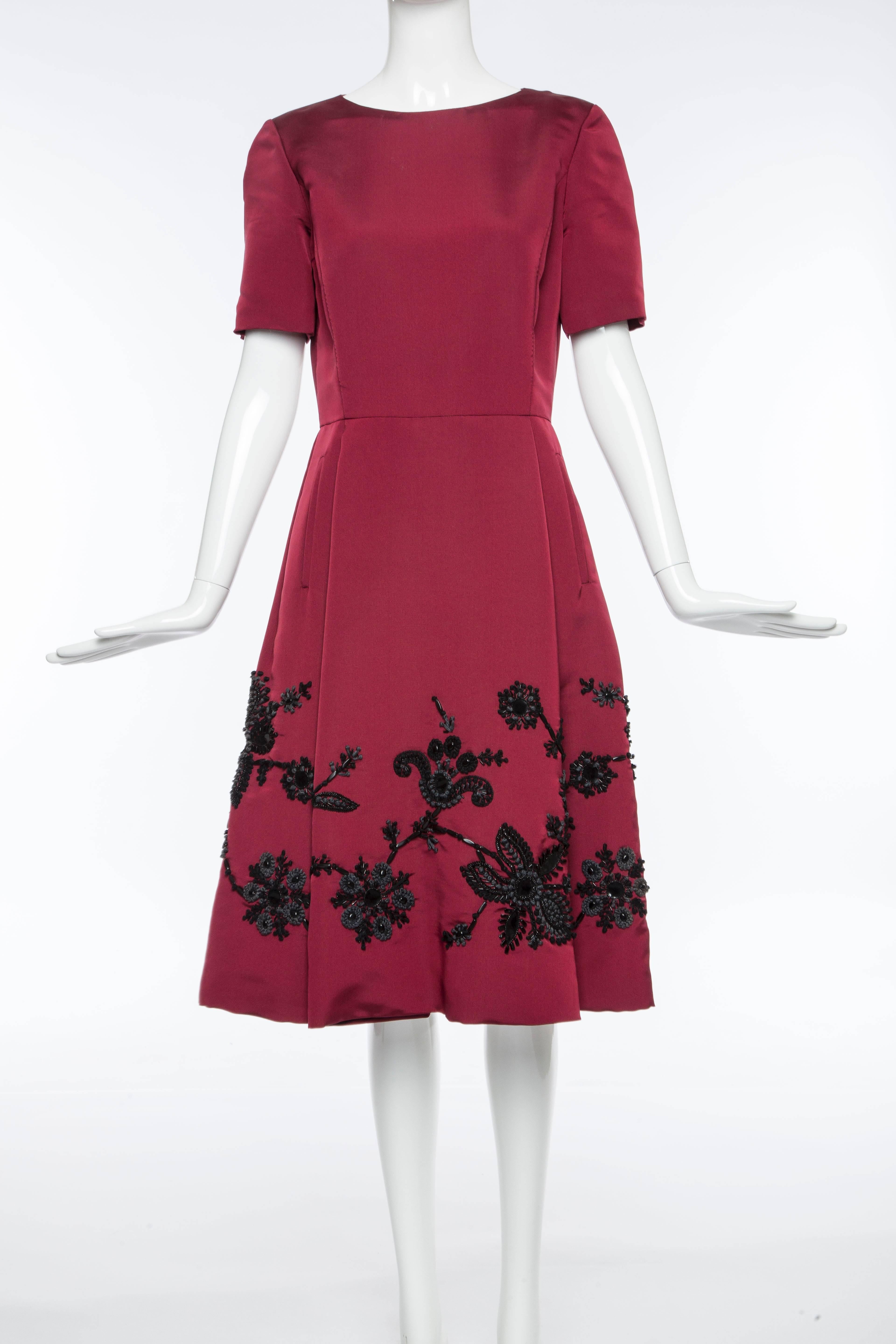 Oscar De la Renta Fall circa 2006 short sleeve silk dress with black embroidery, two front pockets and fully lined in silk.