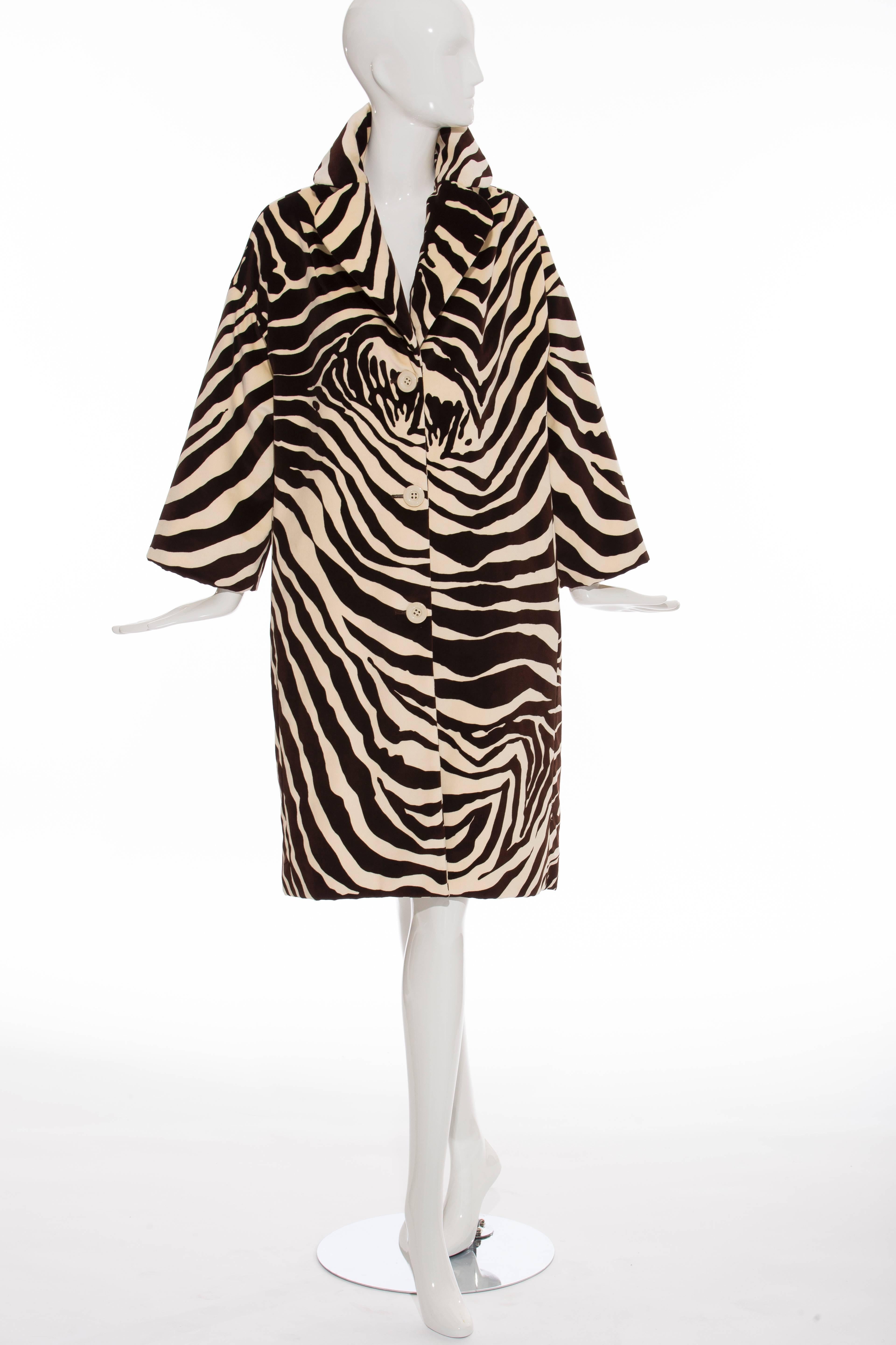 Dolce & Gabbana, Autumn-Winter 1996 cream and chocolate brown cotton velvet coat with zebra print throughout, rounded lapel, three-quarter sleeves, dual seam pockets at front and exposed button closures at center.

IT. 40
US. 4

Bust 48”, Waist