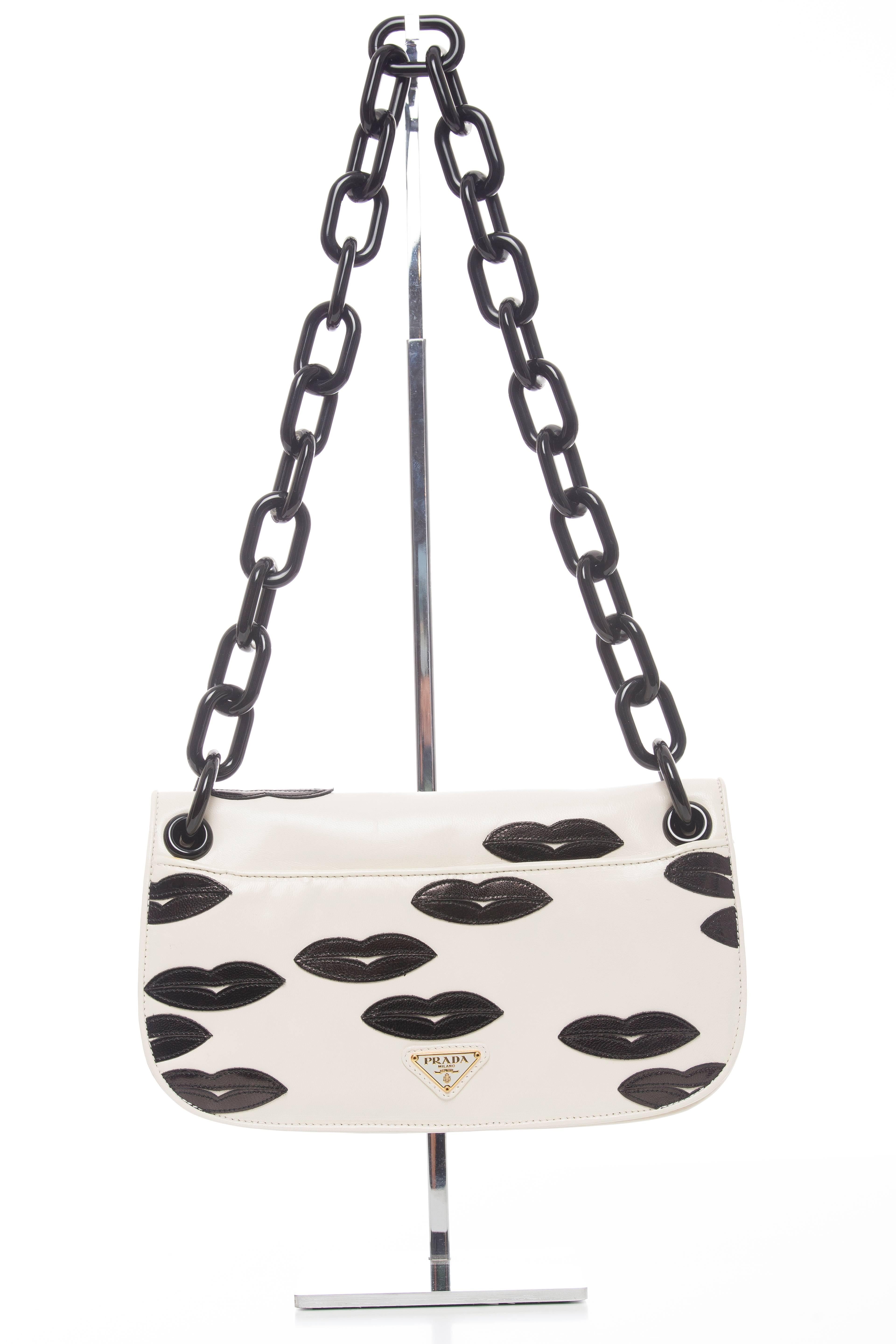  Prada, Resort 2012 leather Madras Flap shoulder bag with resin chain-link shoulder strap, black leather lips throughout, leather lining, wall zip pocket and flap top with twist-lock closure.

Shoulder Strap Drop 12.5, Height 6, Width 10.5, Depth 2
