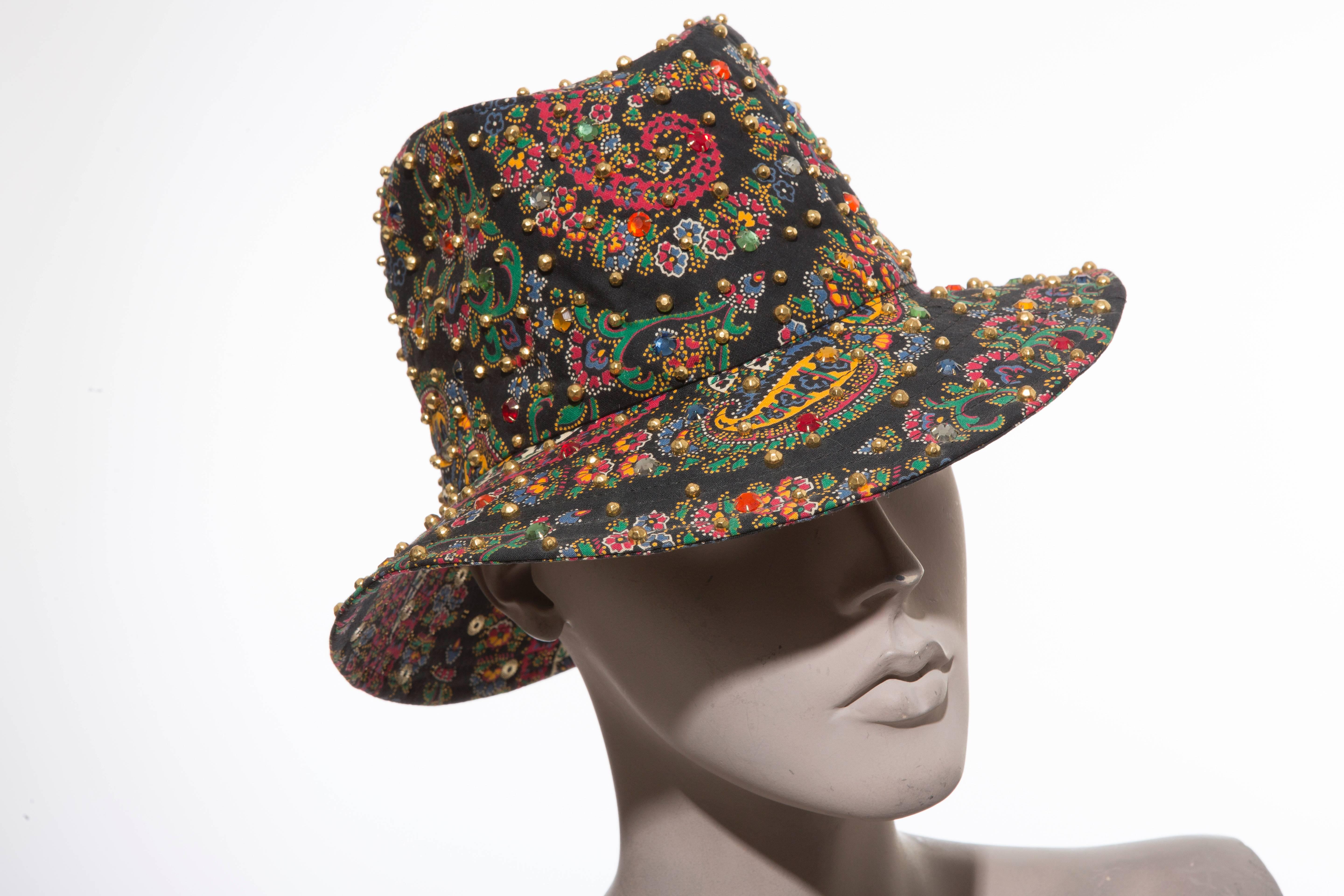Adolfo Realites, circa 1960's paisley fedora hat with polychrome prong set swarovski crystals and brass studs.

Circumference: 23 inch