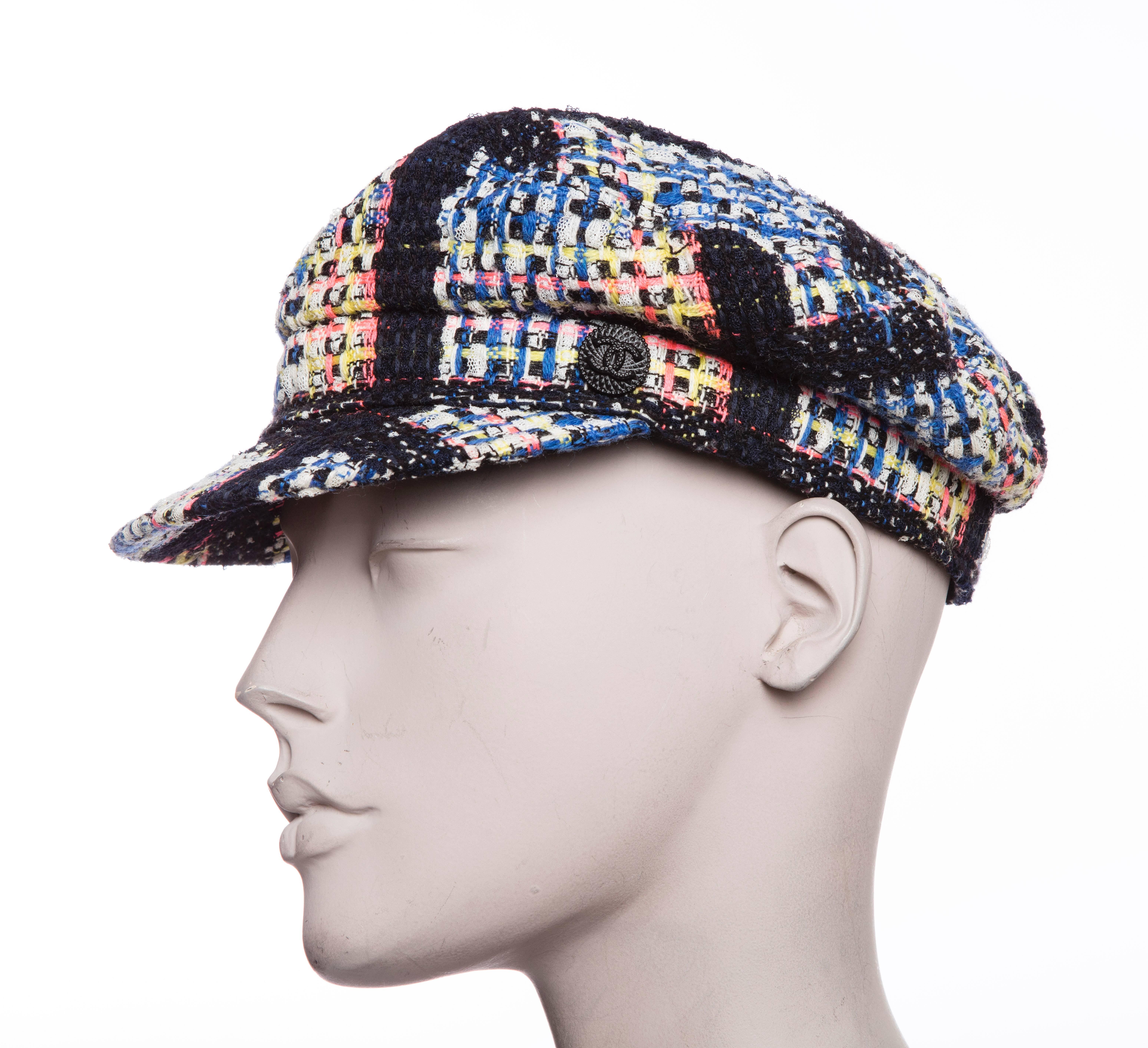 Chanel tweed newsboy cap with CC embellishment at side. 
Designer size 57.

Circumference 23”, Brim 2”
Fabric Content: 59% Wool, 37% Polyamide, 4% Cotton