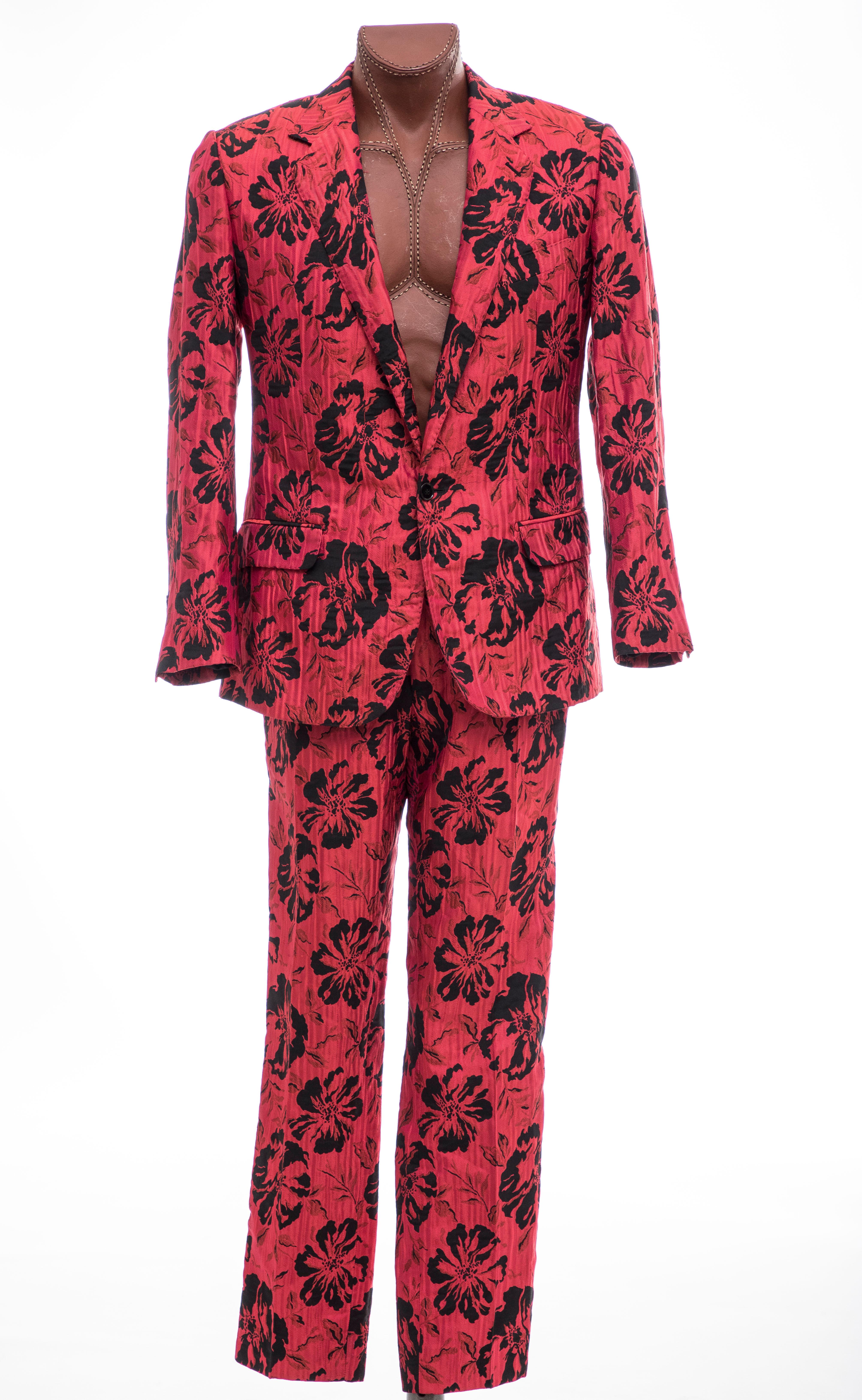  Dolce & Gabbana, Autumn - Winter 2011 red floral jacquard two-piece suit. Jacket features notched lapels, three front pockets, three interior welt pockets, back hem vent and front button closure. Slim-leg pants features two front pockets, two side