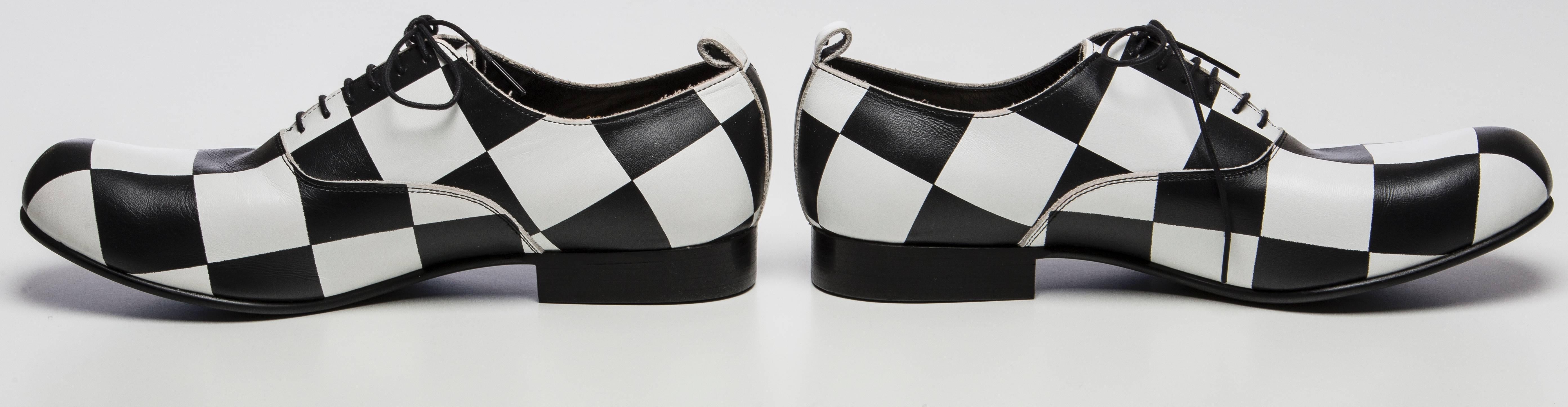  Comme des Garçons, Spring 2015 black & white checkered leather round-toe oxfords with rubber soles and lace tie closure at tops. Made in Japan. Includes dust bag.

Japan 28
US 10.5