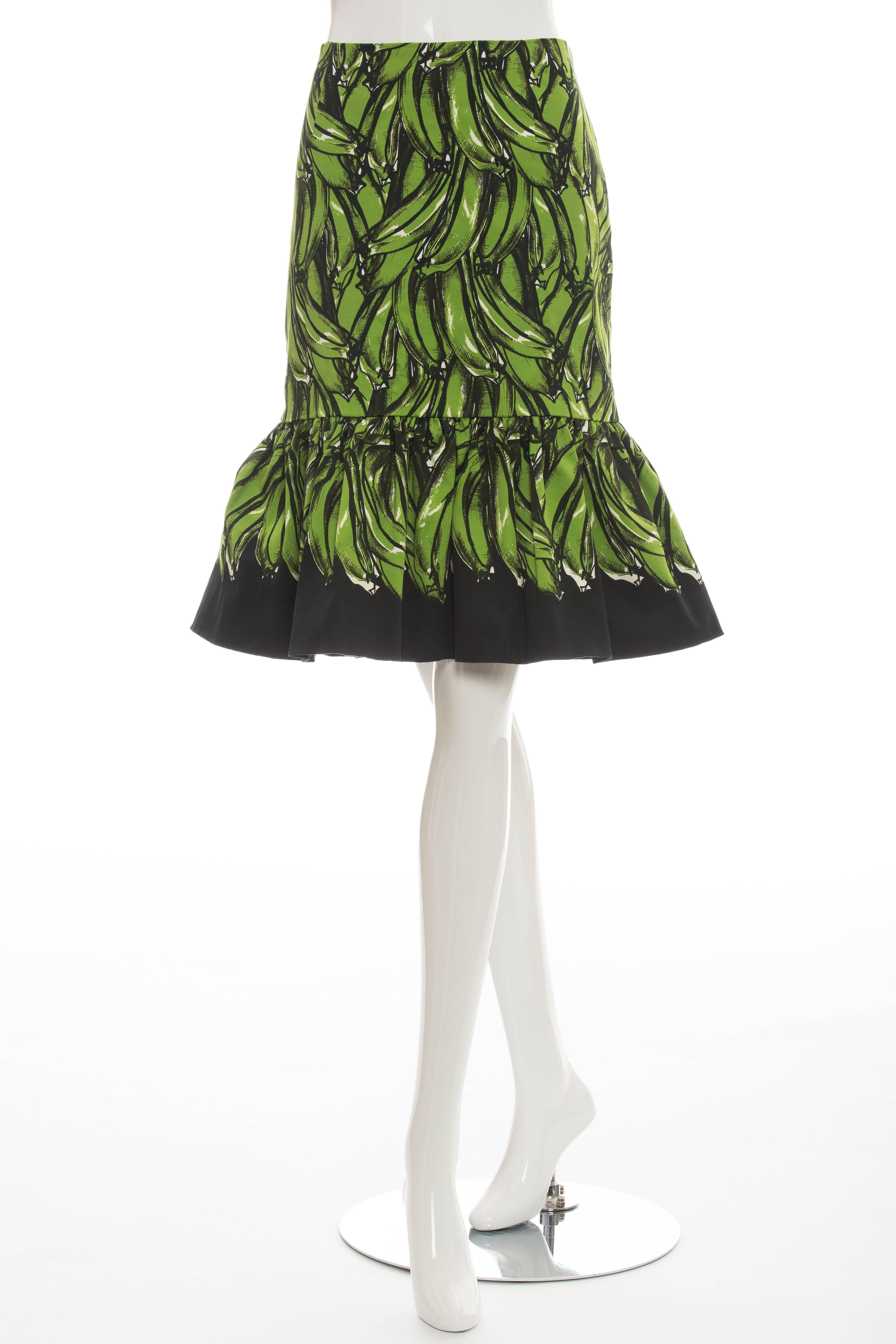 Prada, Spring/Summer 2011 banana print skirt with flared hem and invisible zip closure at side seam.

Waist 29”, Hip 35”, Length 24.5”
Fabric Content: 98% Cotton, 2% Other Fibers; Lining: 74% Cupro, 26% Silk