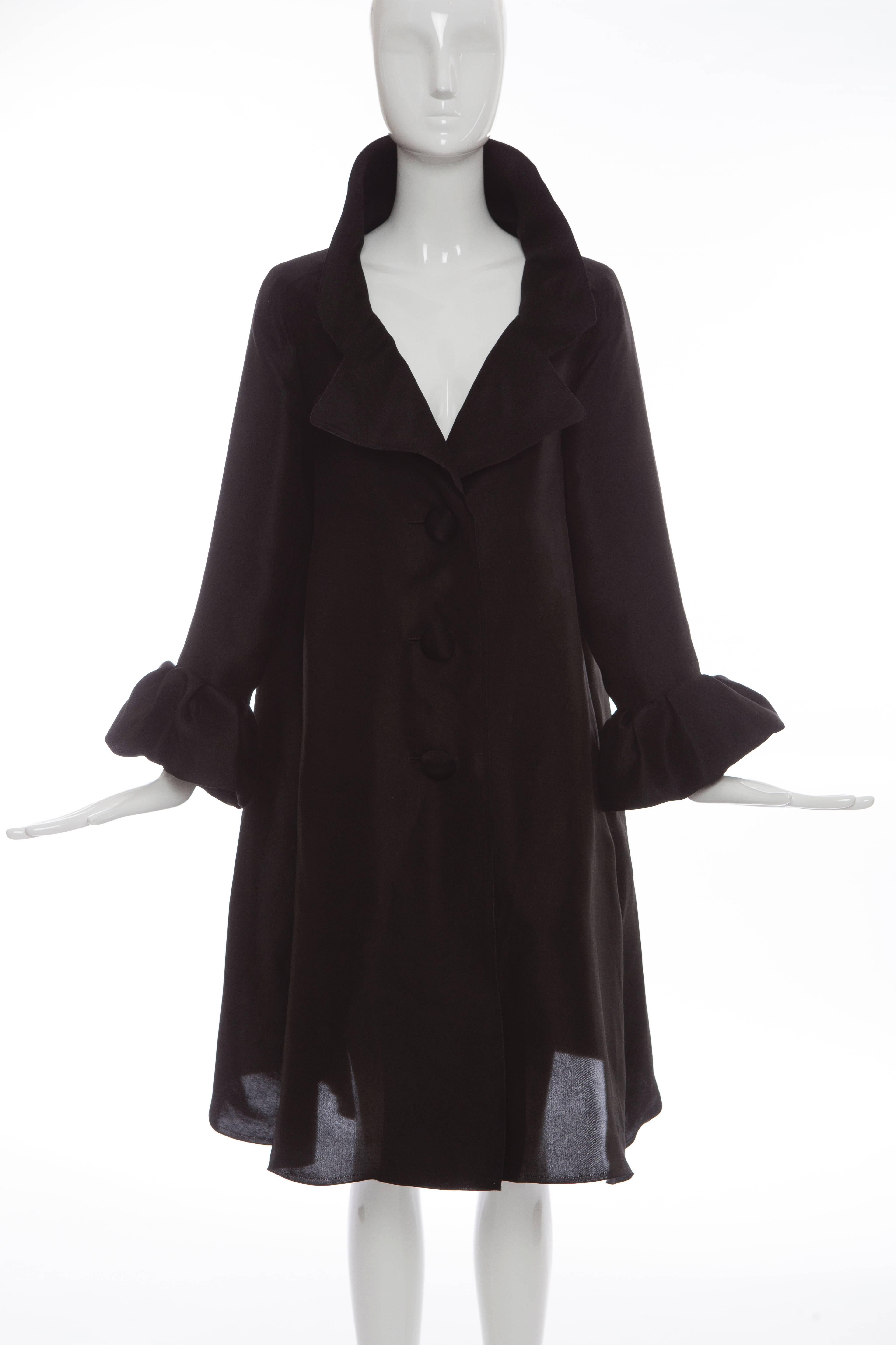  Alber Elbaz for Lanvin Autumn-Winter 2006, black silk lightweight evening coat with notched collar, flounced sleeve, two front pockets at hips and front button closure.

FR. 38
US. 6

 Bust 42”, Waist 48”, Shoulder 16”, Length 39.5”, Sleeve 30”