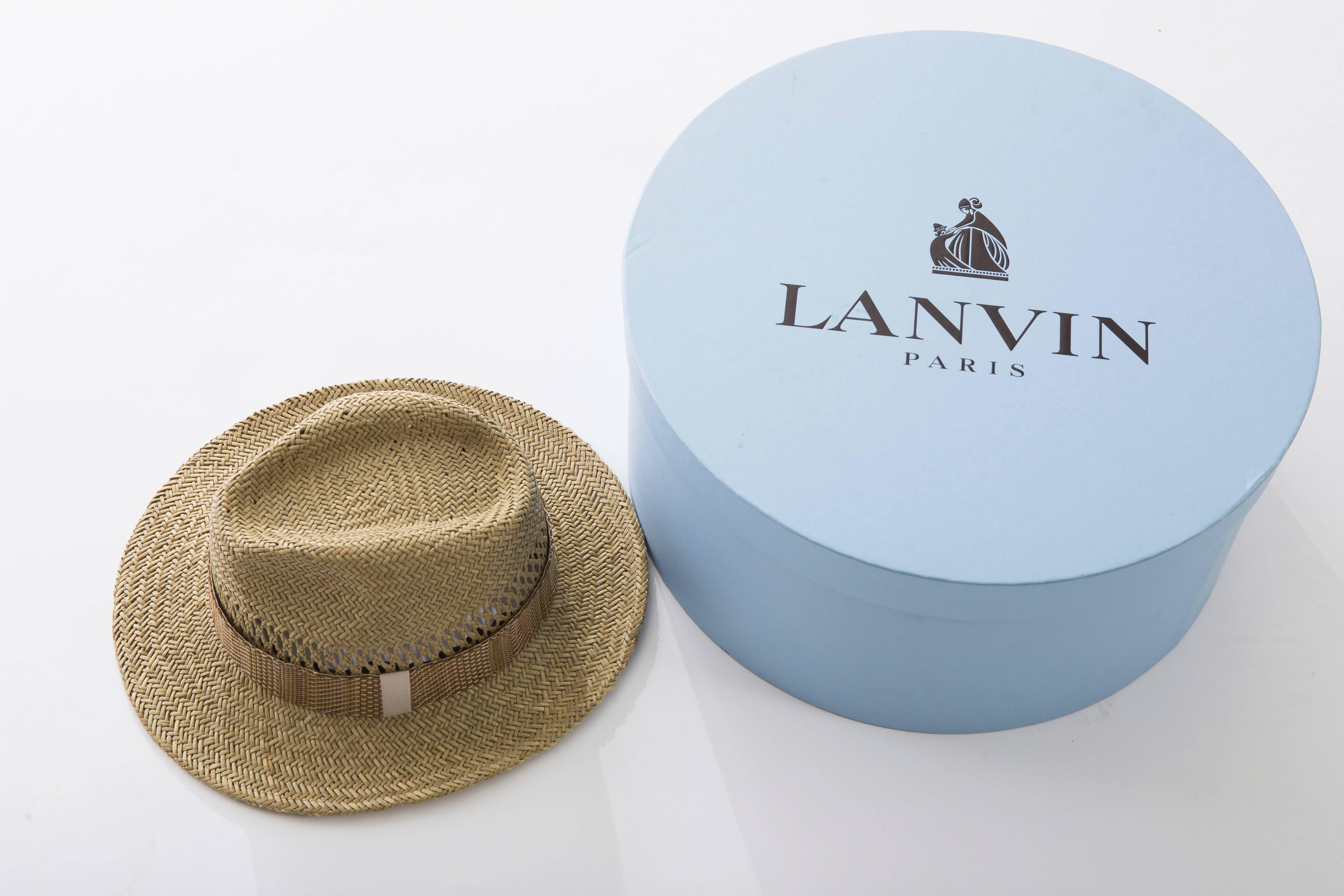 Lanvin men's open weave straw brimmed hat with grosgrain accent at interior. Includes box.

Circumference 16", Brim 2.5"
Fabric Content: 100% Straw