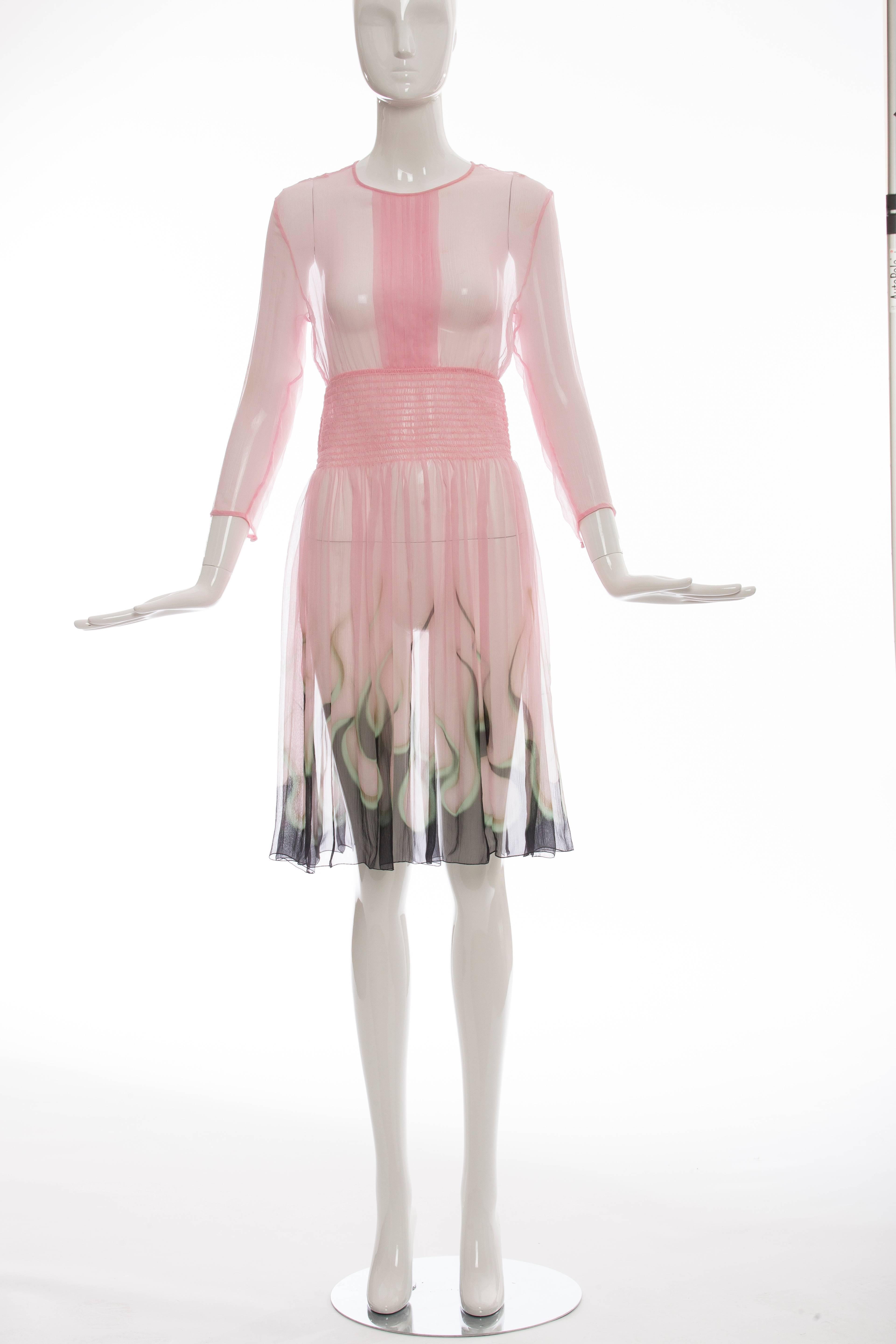 Prada, Spring 2012 pink silk chiffon dress with long sleeves, smocked waist, flame print at hem and single button closure at nape.

IT, 40
US. 4

Bust 38”, Waist 26”, Hip 60”, Length 39”
Fabric Content: 100% Silk