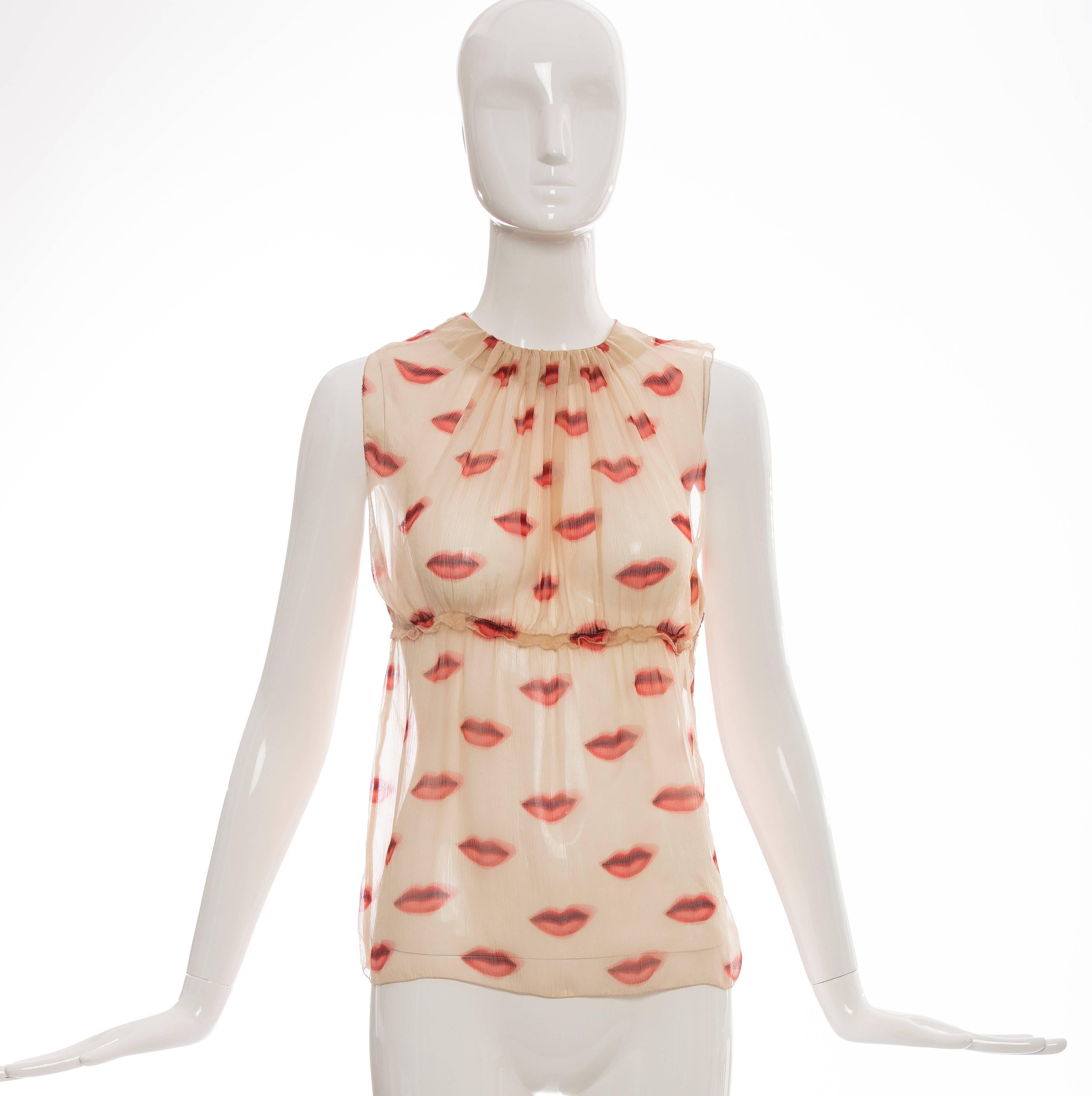 Prada, Spring - Summer 2000 sleeveless silk chiffon top with lip print throughout, crew neck, pleating detail at front, ruffle waistband and hidden side snap closures.

IT. 38
US. 2

 Bust 28”, Waist 24”, Length 24”