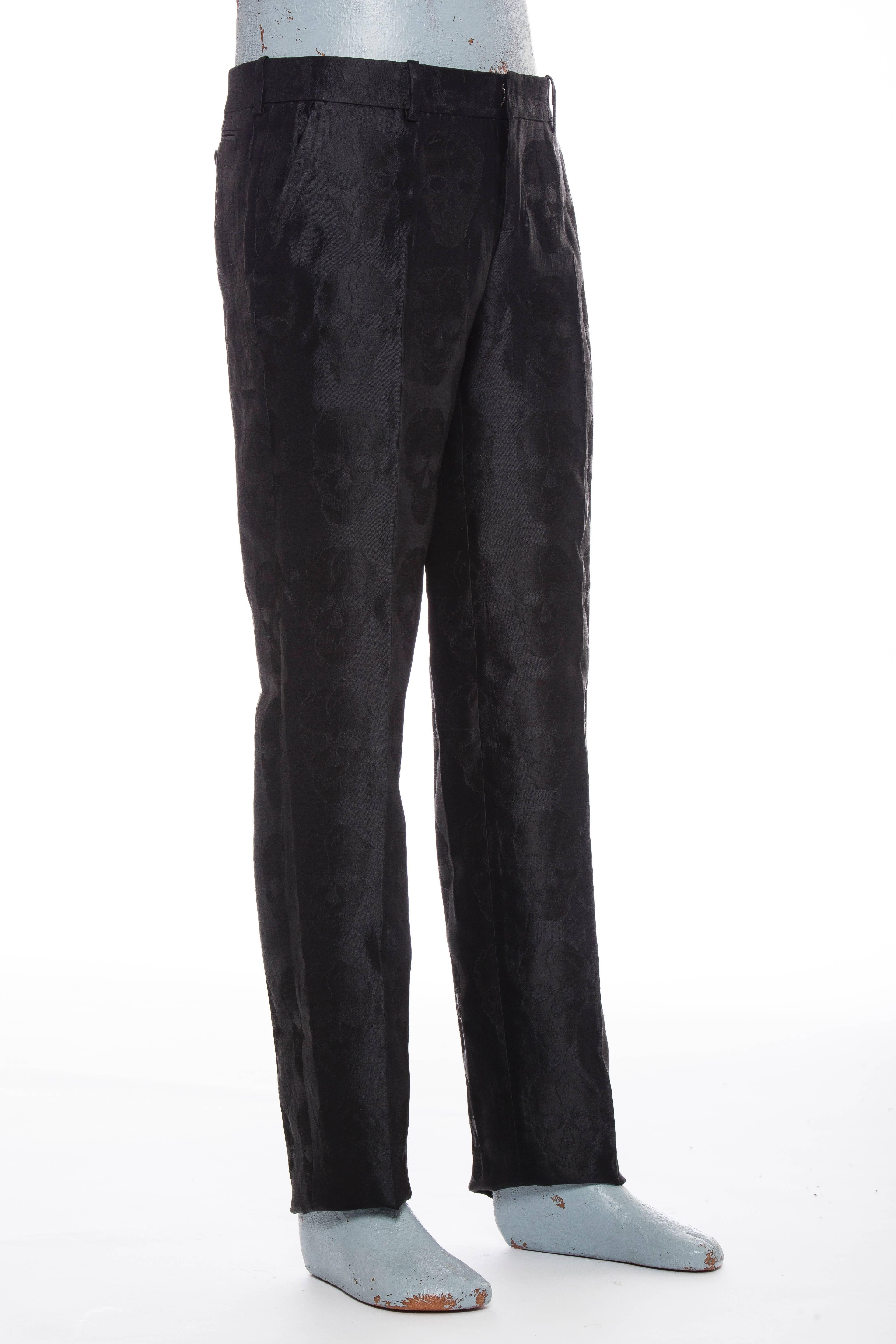  Alexander McQueen men's silk straight-leg pants with skull pattern throughout, dual slit pockets at sides, welt pockets at back, tonal stitching and hidden zip closure at center front.

IT. 48
US.32

Waist 33”, Rise 9”, Inseam 36”, Leg Opening