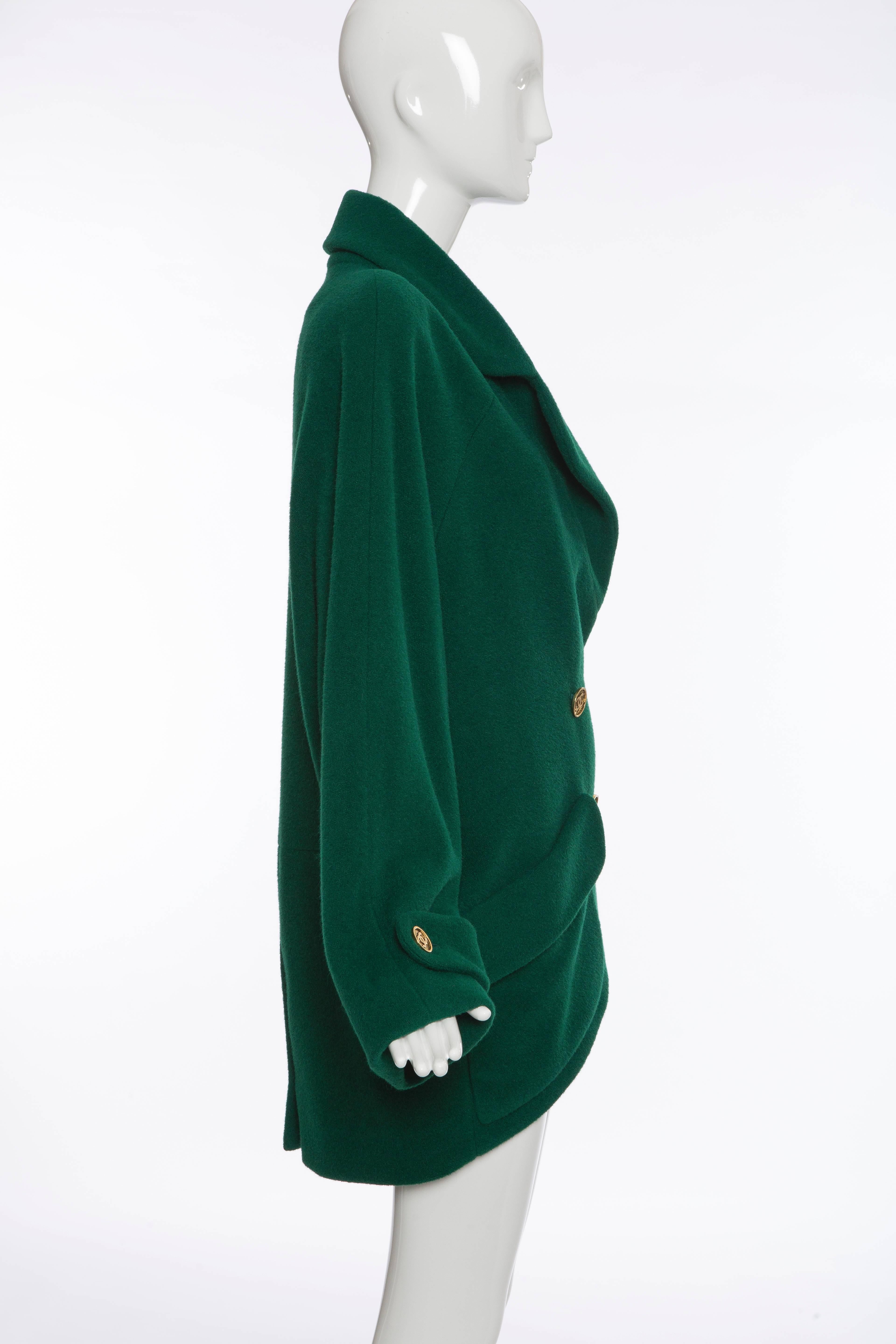 Chanel , circa 1980's, emerald green double-breasted cocoon coat with notched lapels, dual patch pockets, straps at cuffs, gold-tone CC buttons, back single vent and fully lined in silk.

Size not listed, estimated from measurements.

Bust 40”,