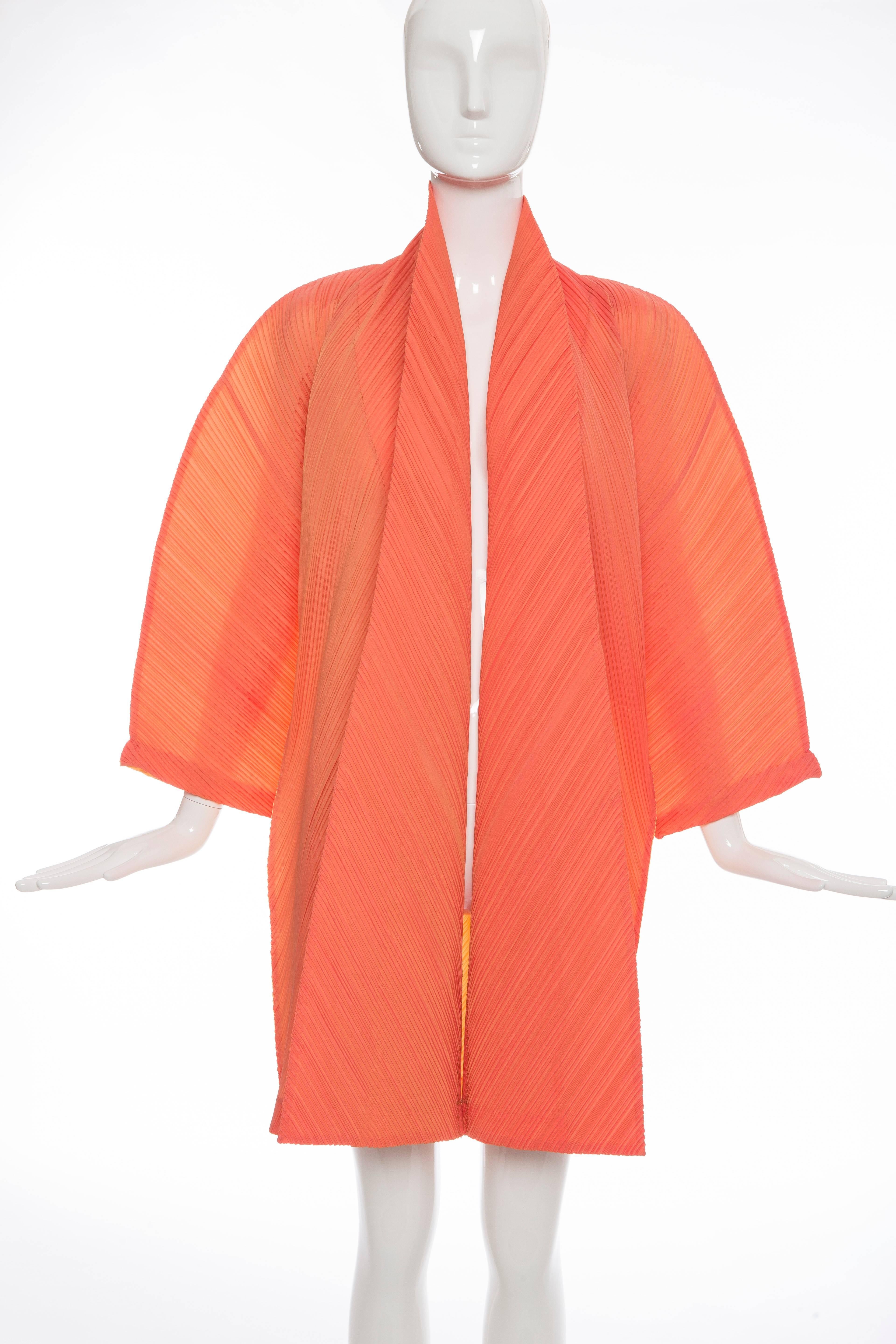 Issey Miyake, Spring-Summer 1995, coral front with yellow back pleated polyester cocoon jacket with black on white woven label.

Bust: 58, Waist: 58, Length: 36