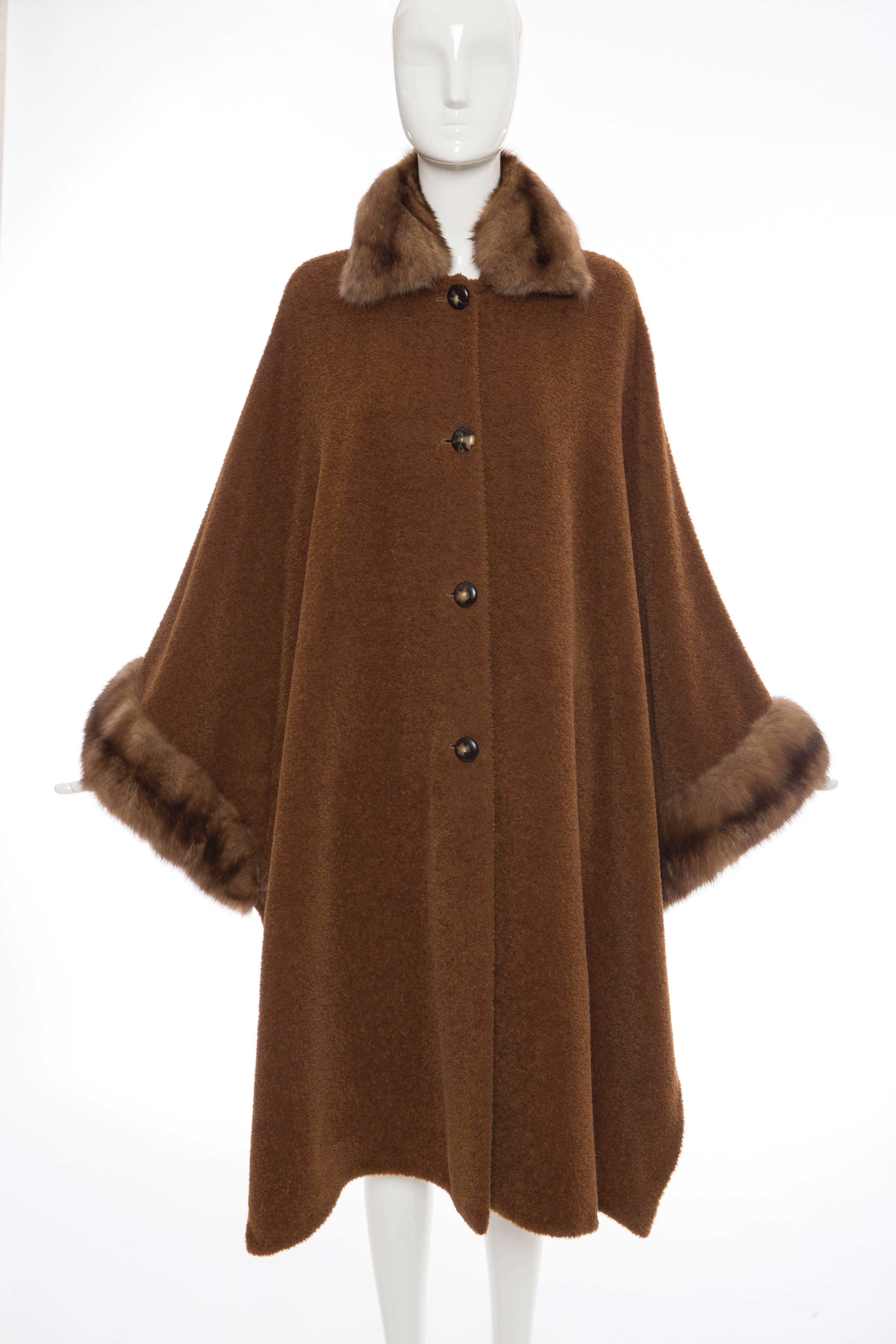 Revillon, late 20th Century, button front cinnamon alpaca cloak/cape with sable trim, side snap closures and one extra button.

No Size Label

Bust: 84, Waist: 84, Hips: 78, Length: 44