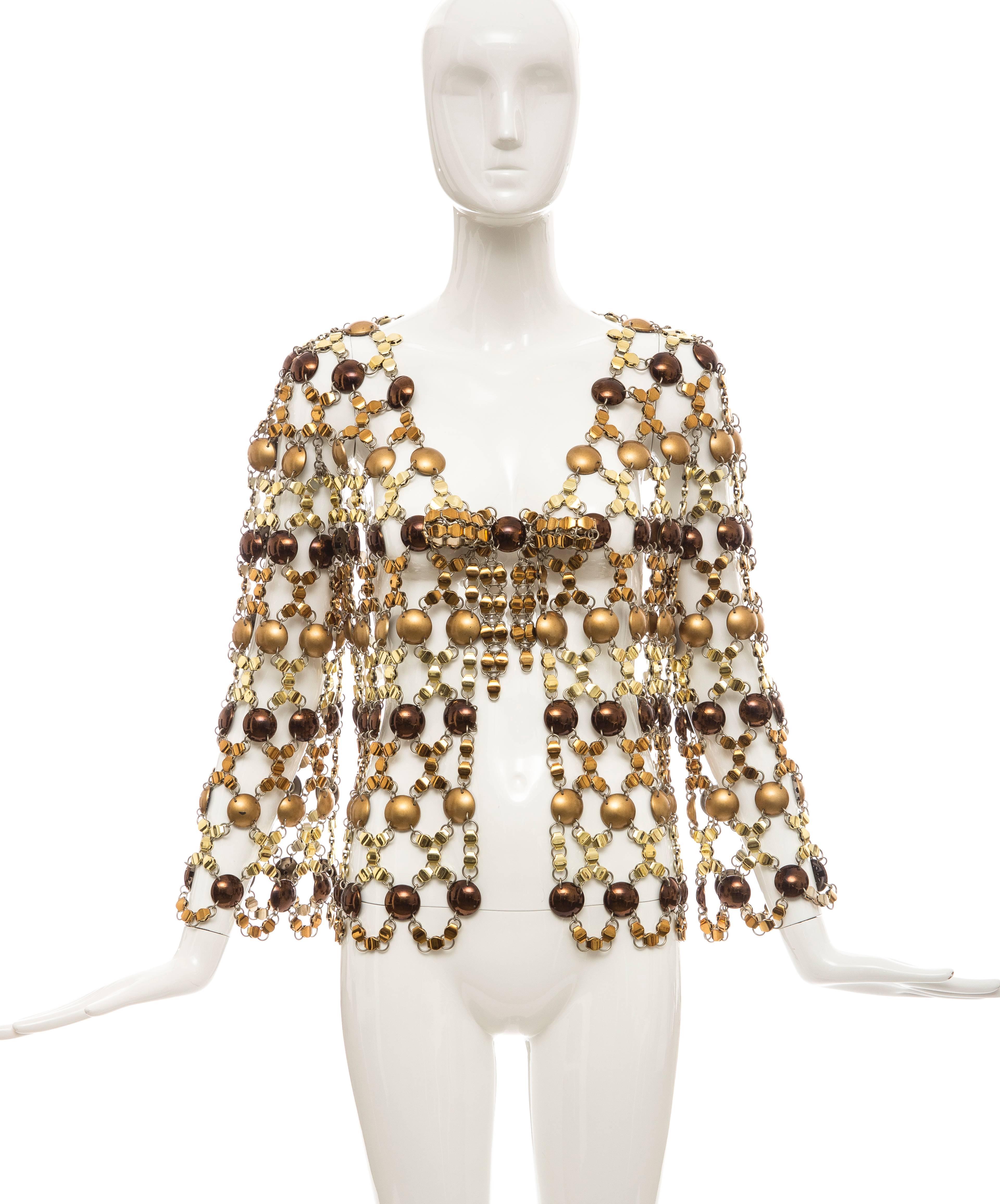 Paco Rabanne, circa 1970's, chain mail top consisting of bronze and copper plastic circular disks with bronze and gold metal links and numbered fabric tag.

Shoulder: 17, Bust: 36, Length: 16, Waist: 36