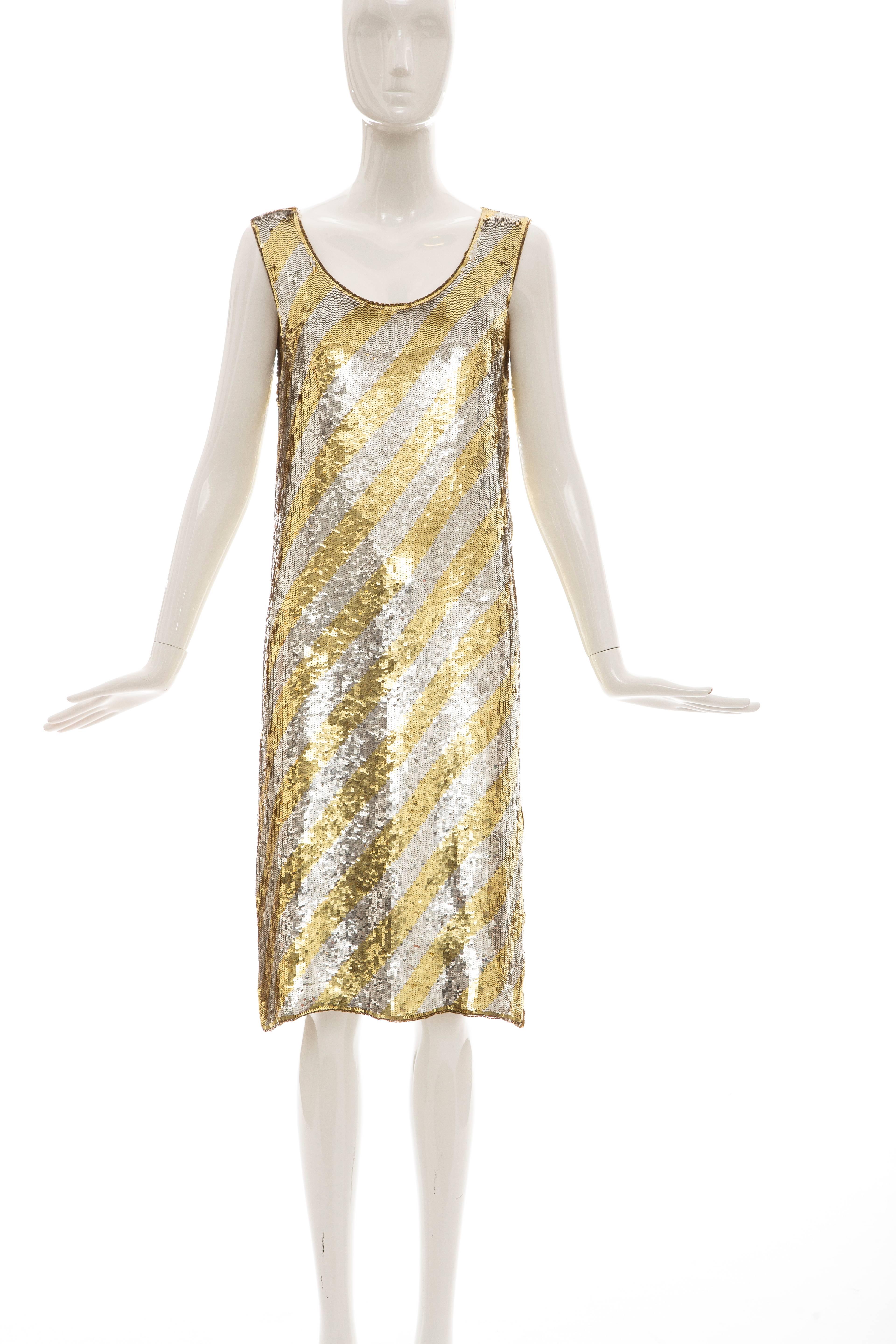 Christian Dior by Marc Bohan, circa 1970's, sleeveless shift dress with diagonal stripe embroidery of gold and silver sequins, side zip and fully lined.

Bust: 36, Waist: 34, Length: 40.5