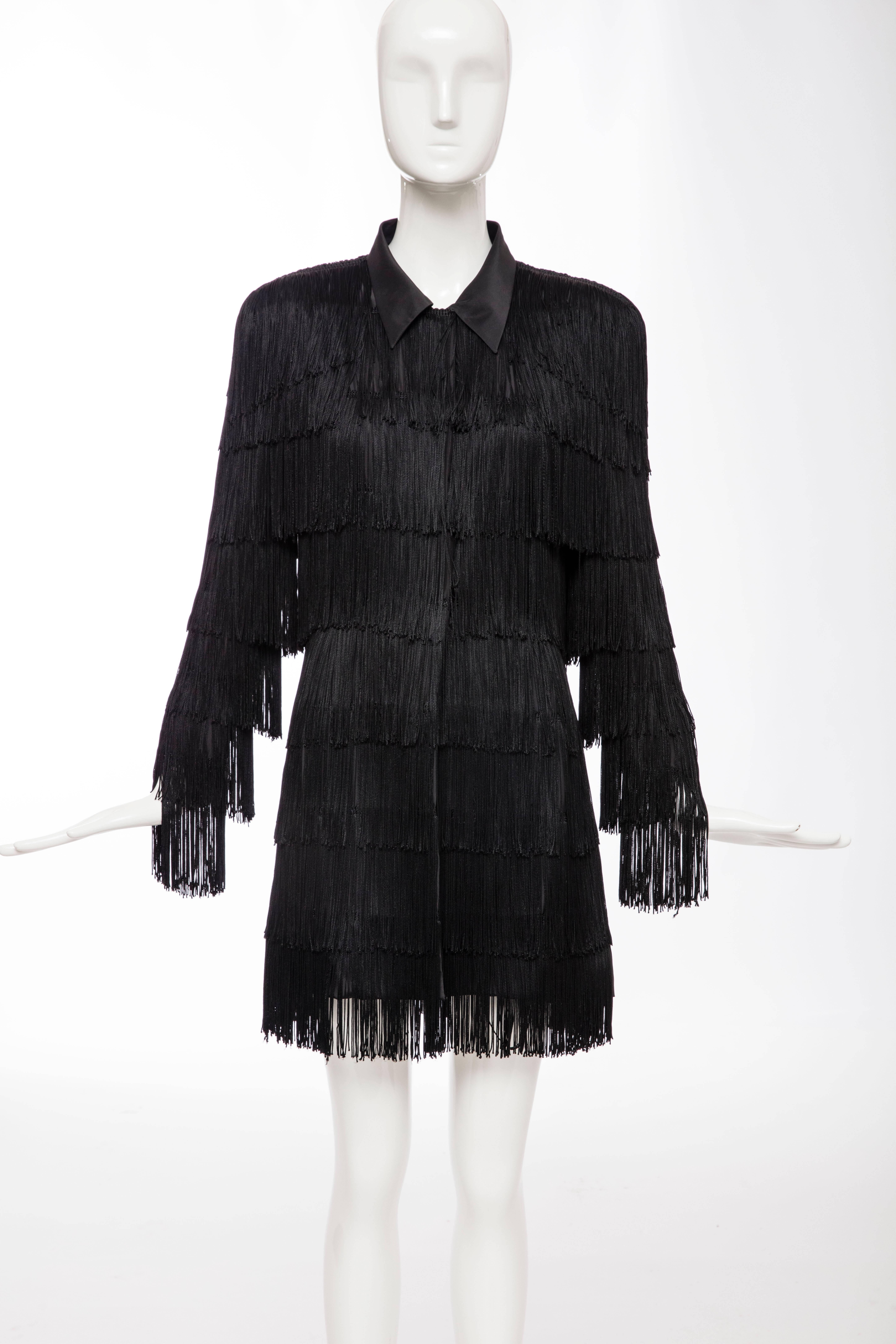 Norma Kamali OMO, circa 1980's, black fringe long jacket with front hidden button placket and hook-and-eye closure, shoulder pads and fully lined.

US. 6

Bust 38, Waist 32, Hips 38, Length 33.5