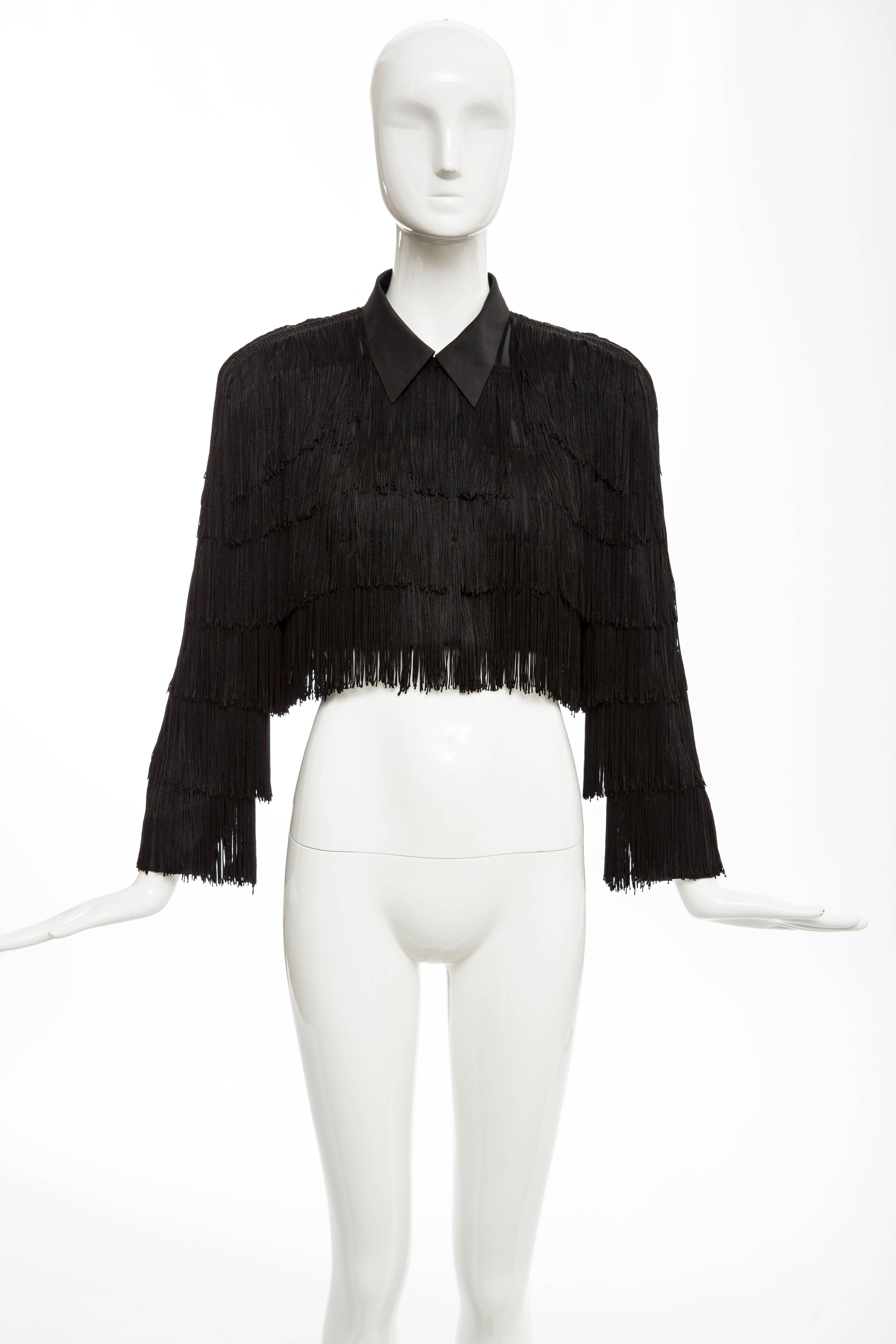 Norma Kamali OMO, circa 1980's, black fringe cropped jacket with front hidden button placket and hook-and-eye closure, shoulder pads and fully lined.

US. 6

Bust 39, Waist 30, Length 15