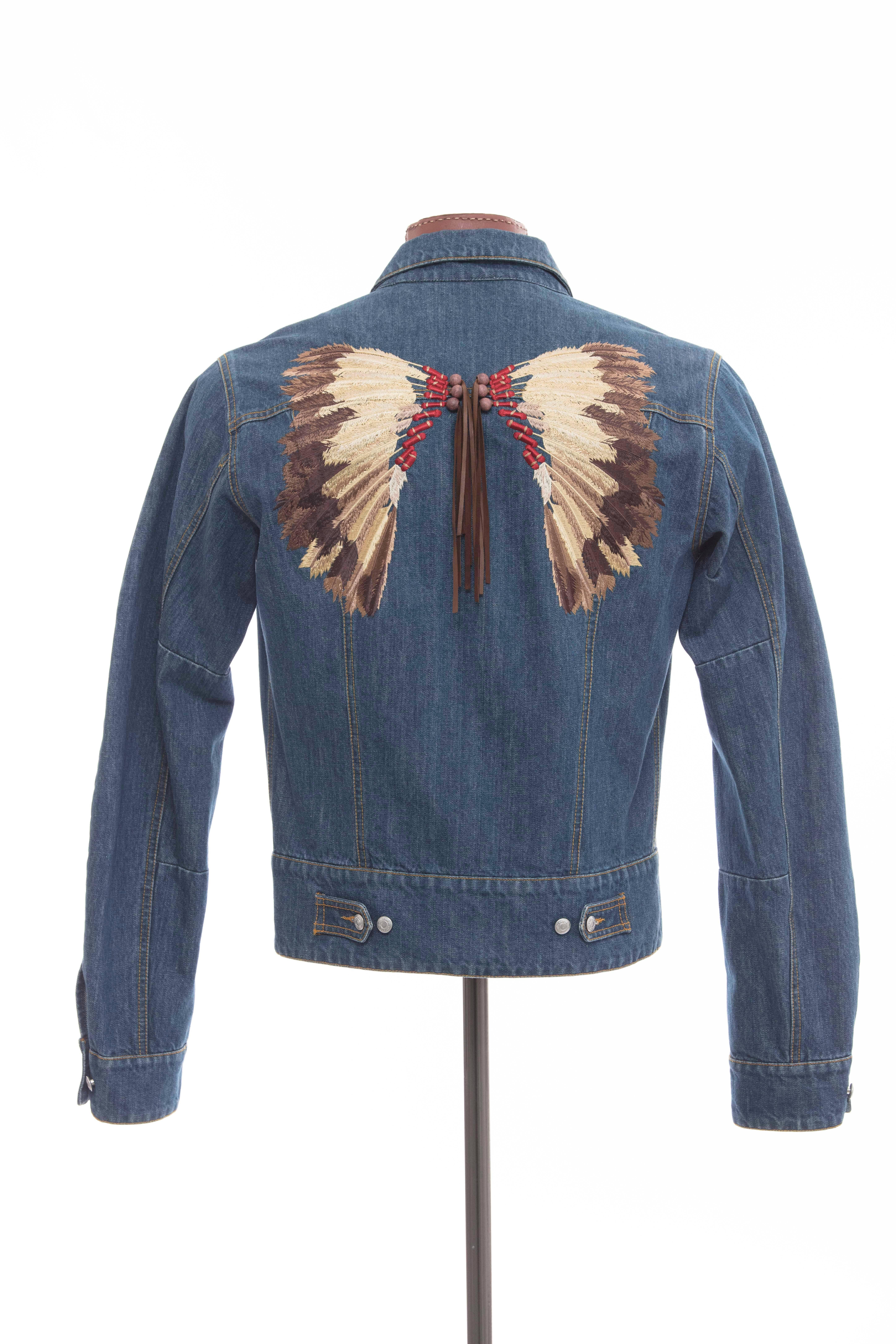 John Galliano men's embroidered denim jacket, button front and two front pockets, embroidered back with wood beads and leather fringe.

EU. size 50