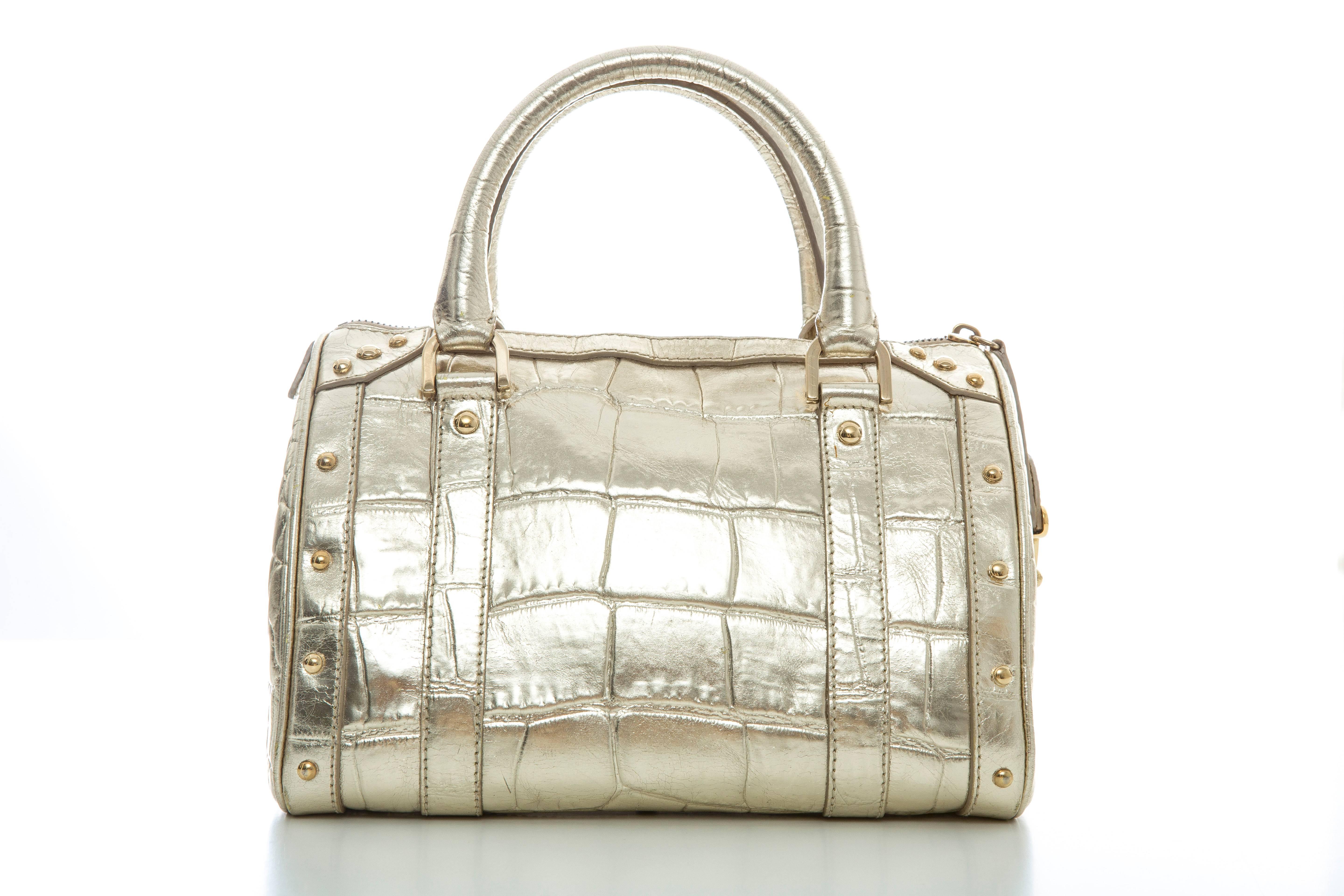 Versace Madonna embossed metallic gold leather top handle handbag with two interior pockets, one with zip, lock and key and fully lined is satin.