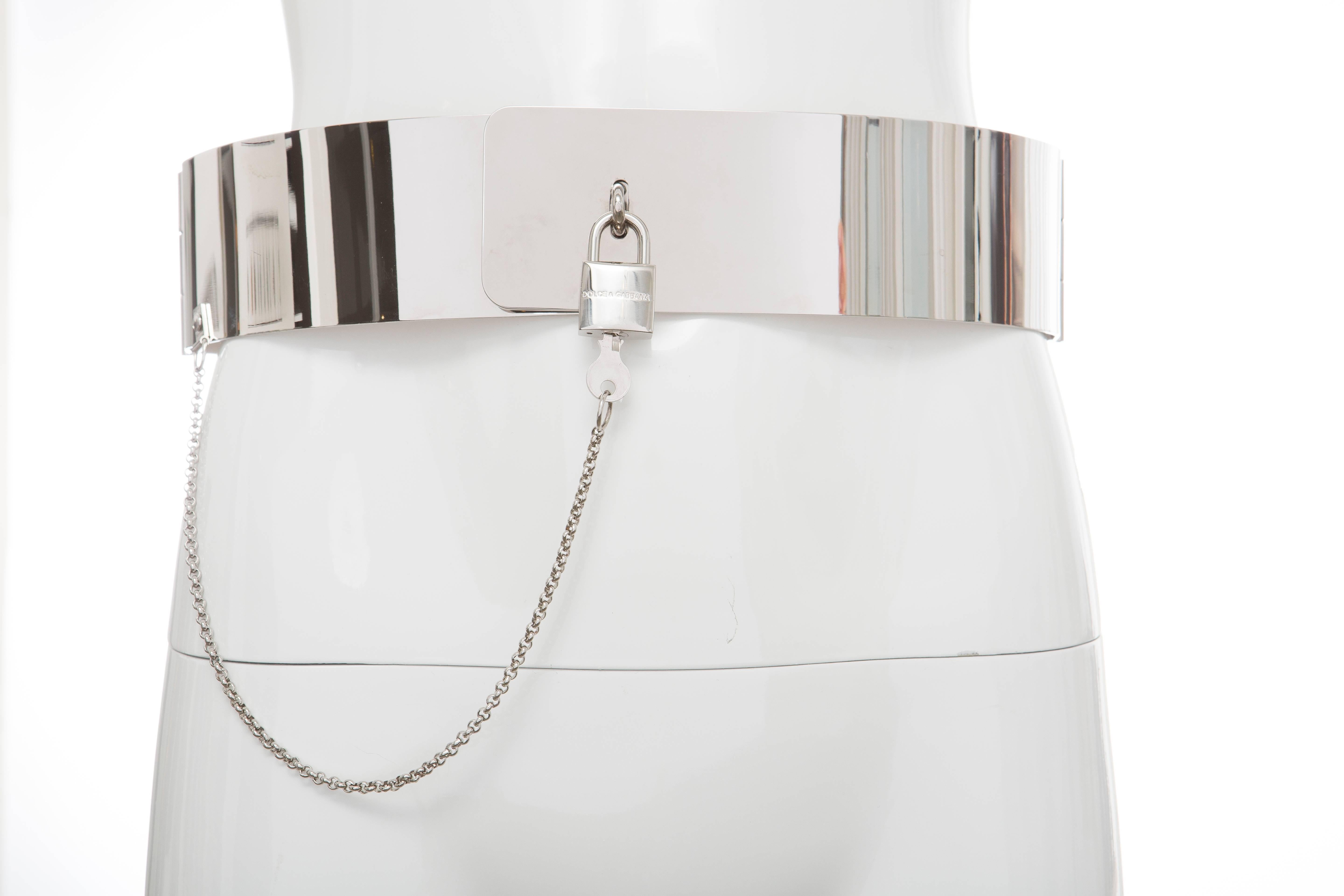 Dolce & Gabbana, Autumn - Winter 2007 metallic silver-tone hardware belt with hinges at sides and padlock and key closure at front.

Small
Length Min: 29
Length Max: 30
Width: 2.25