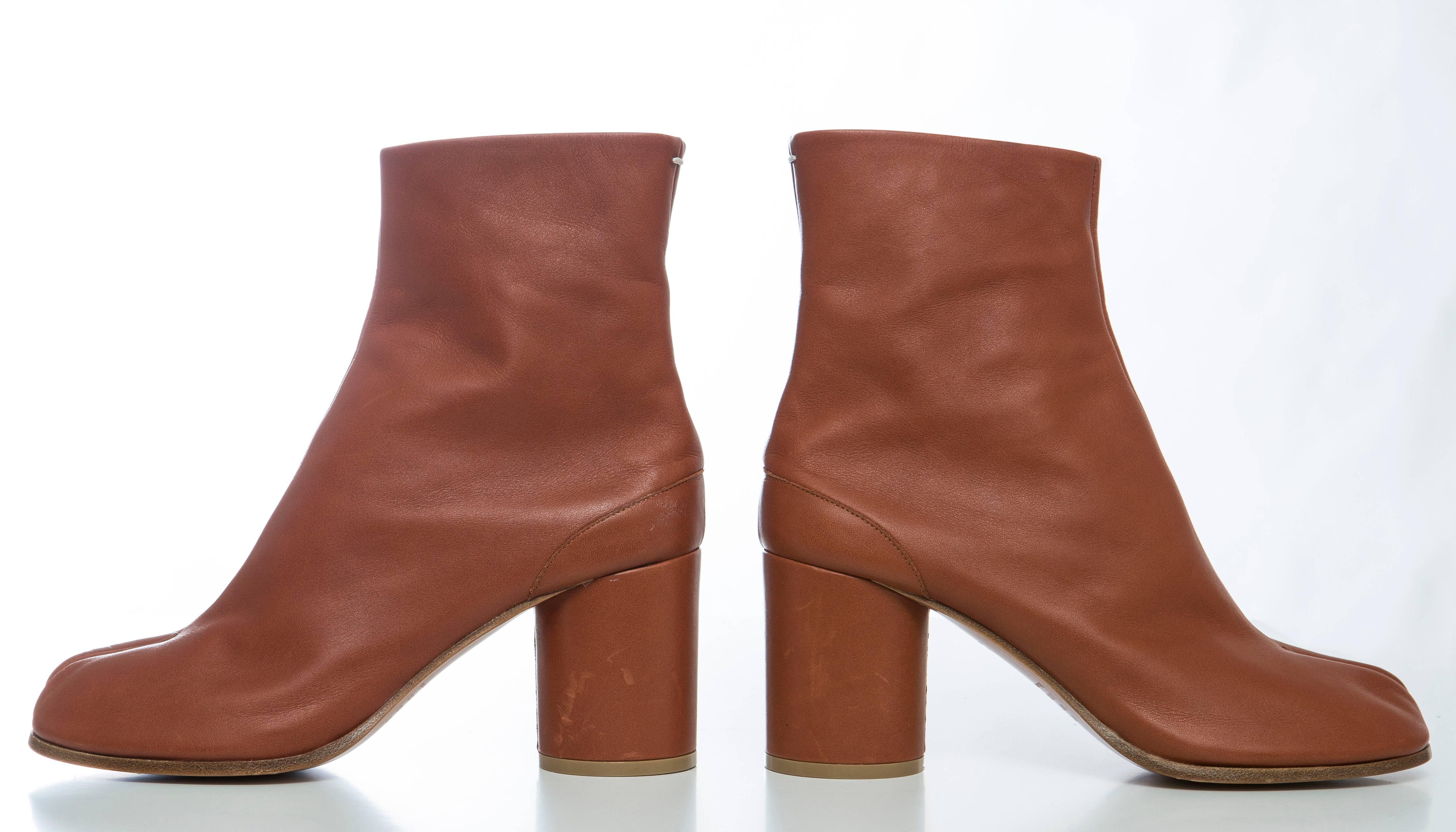 Maison Martin Margiela cognac leather Tabi ankle boots with tonal stitching and hook closures at backs.

EU. 40
US. 10