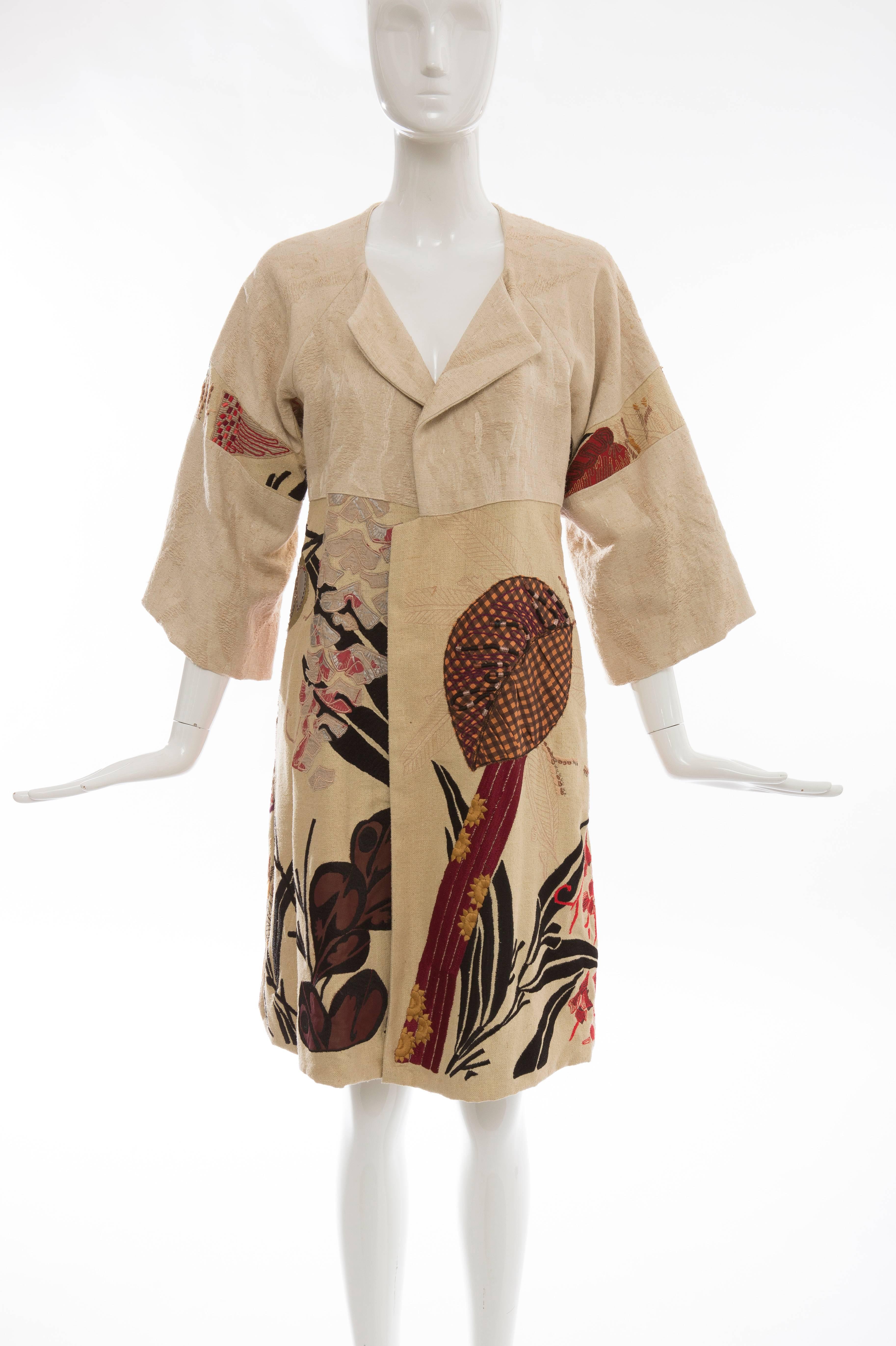 Dries Van Noten, Spring-Summer 2006, silk-cotton embroidered patchwork coat with open front, dual welt pockets, single pleat at center back and tonal stitching throughout.

Size: Small
Bust: 32
Waist: 30
Shoulder: 15
Length: 38
Sleeve: 25
