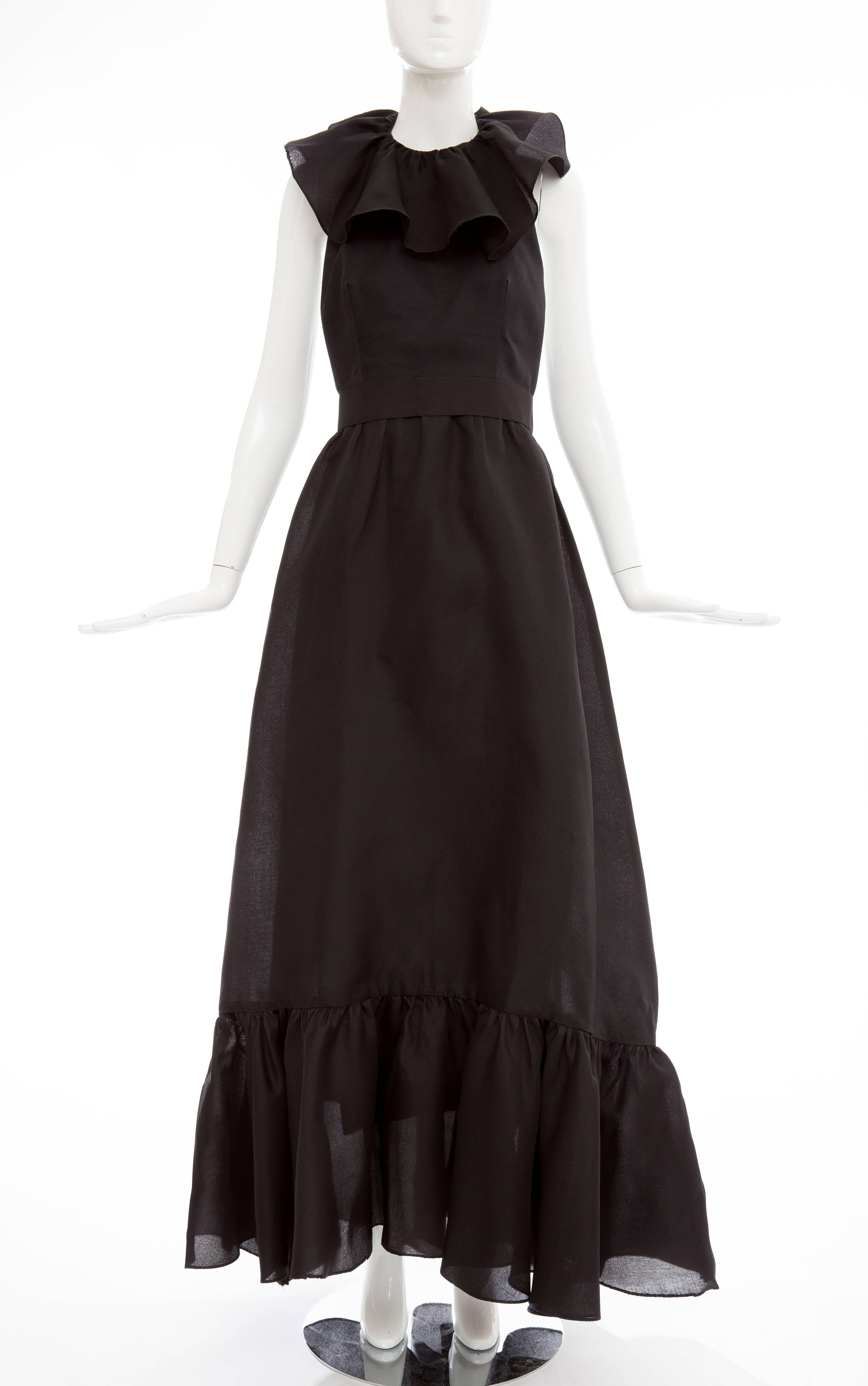 Nina Ricci, circa 1970's black silk gazar evening dress, ruffled halterneck, bow back with snap and hook-&-eye closure, flounce skirt with banded waist zip back and fully lined.

Bust 29, Waist 27, Hip 52, Length 60