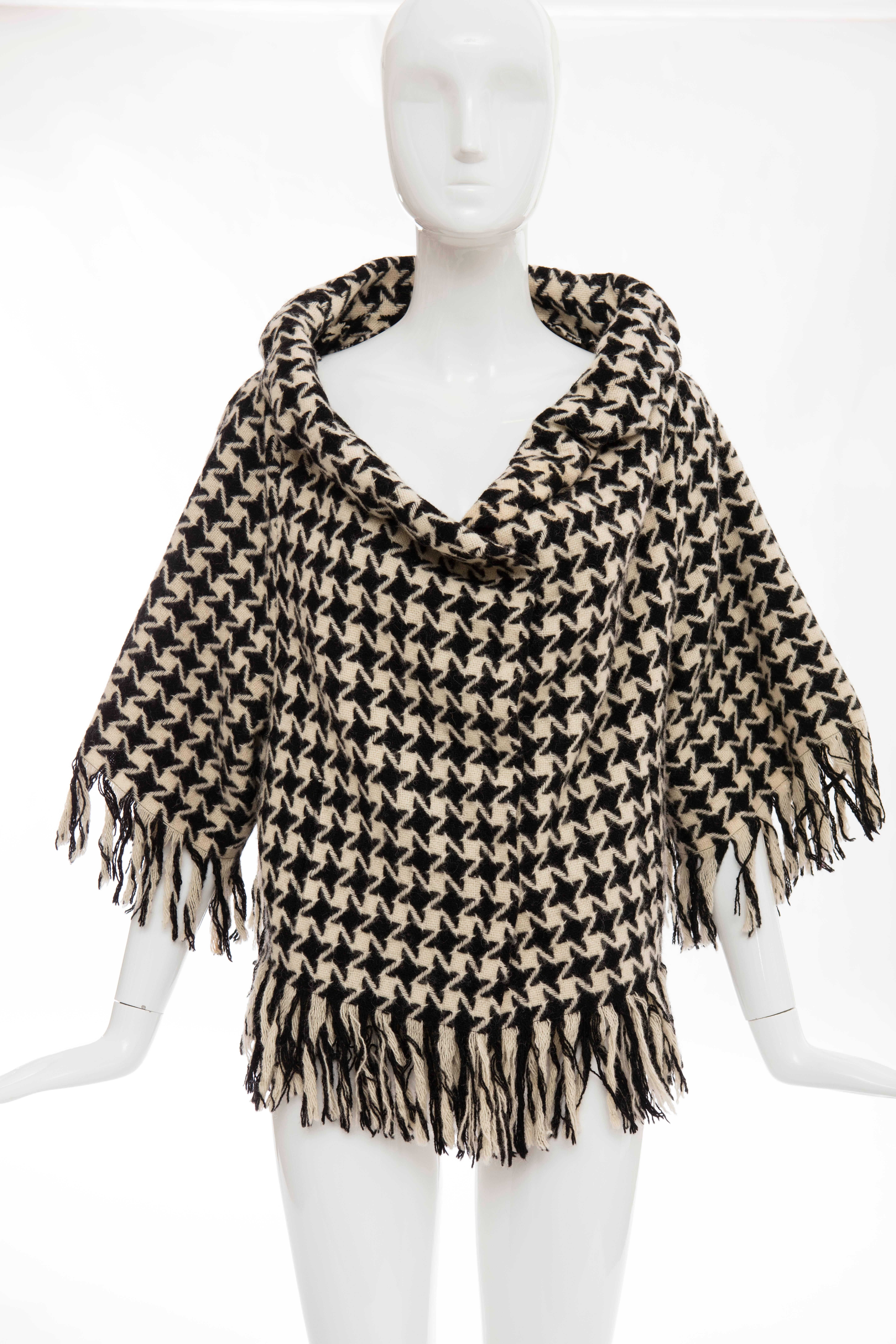 Yohji Yamamoto, Autumn-Winter 2003 wool houndstooth concealed snap front jacket with fringe trim,three quarter length sleeves, dual slit front pockets and fully lined.

Japan: Size 3

Bust 46, Waist 40, Shoulder 19.5, Length 22, Sleeve 24
