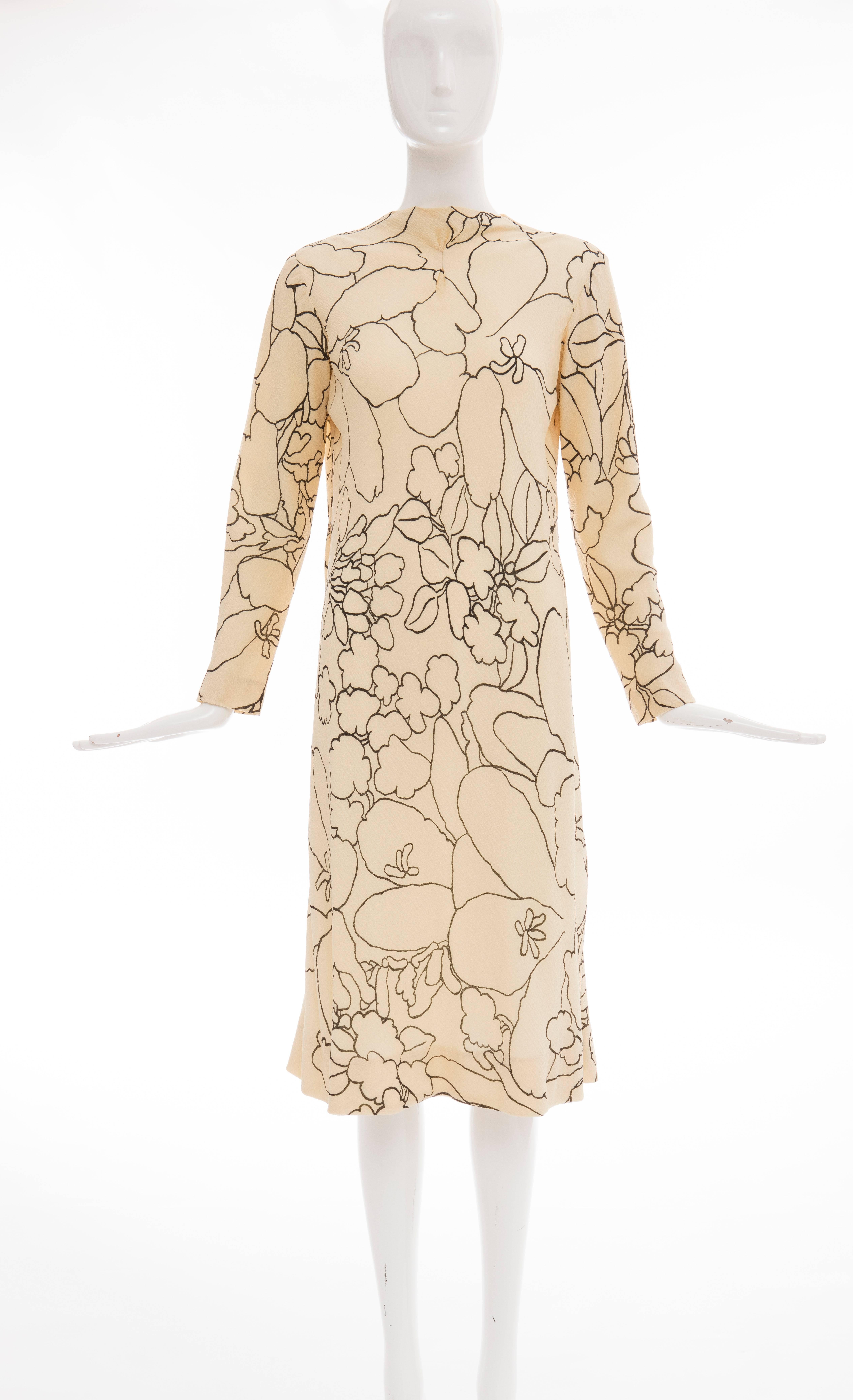 Pauline Trigere, circa 1980's cream and black floral silk crepe long sleeve dress with detached scarf and sash, back zip and fully lined.

Bust: 40, Waist: 40, Hips: 51, Length 44