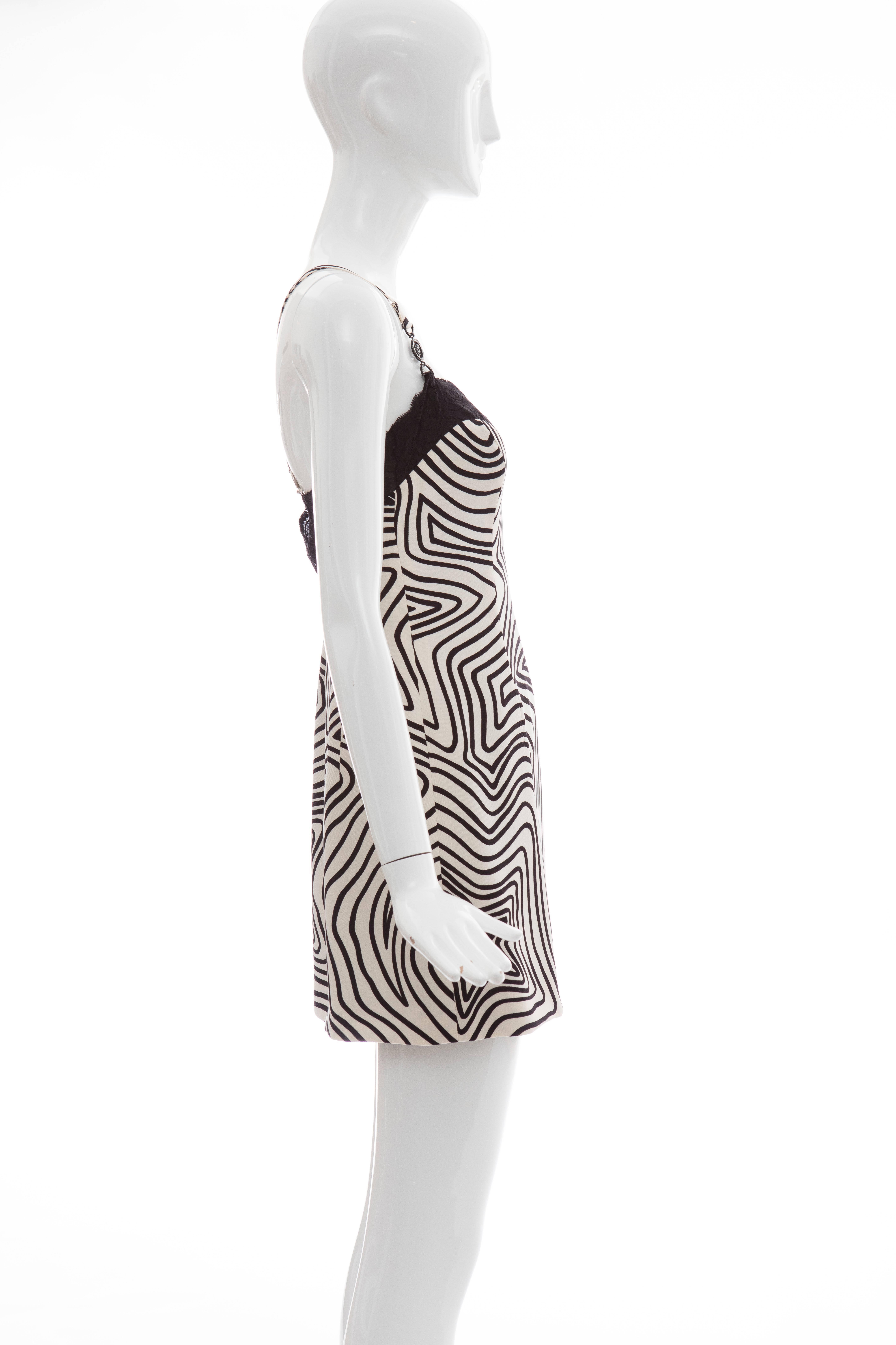 Versace Couture Bergdorf Goodman Label, circa 1990's silk graphic print black and white slip dress with black lace trim, side zip, swarovski embellishments and fully lined in silk.

IT. 38
US. 2

Bust 28, Waist 27, Hips 34, Length 26

