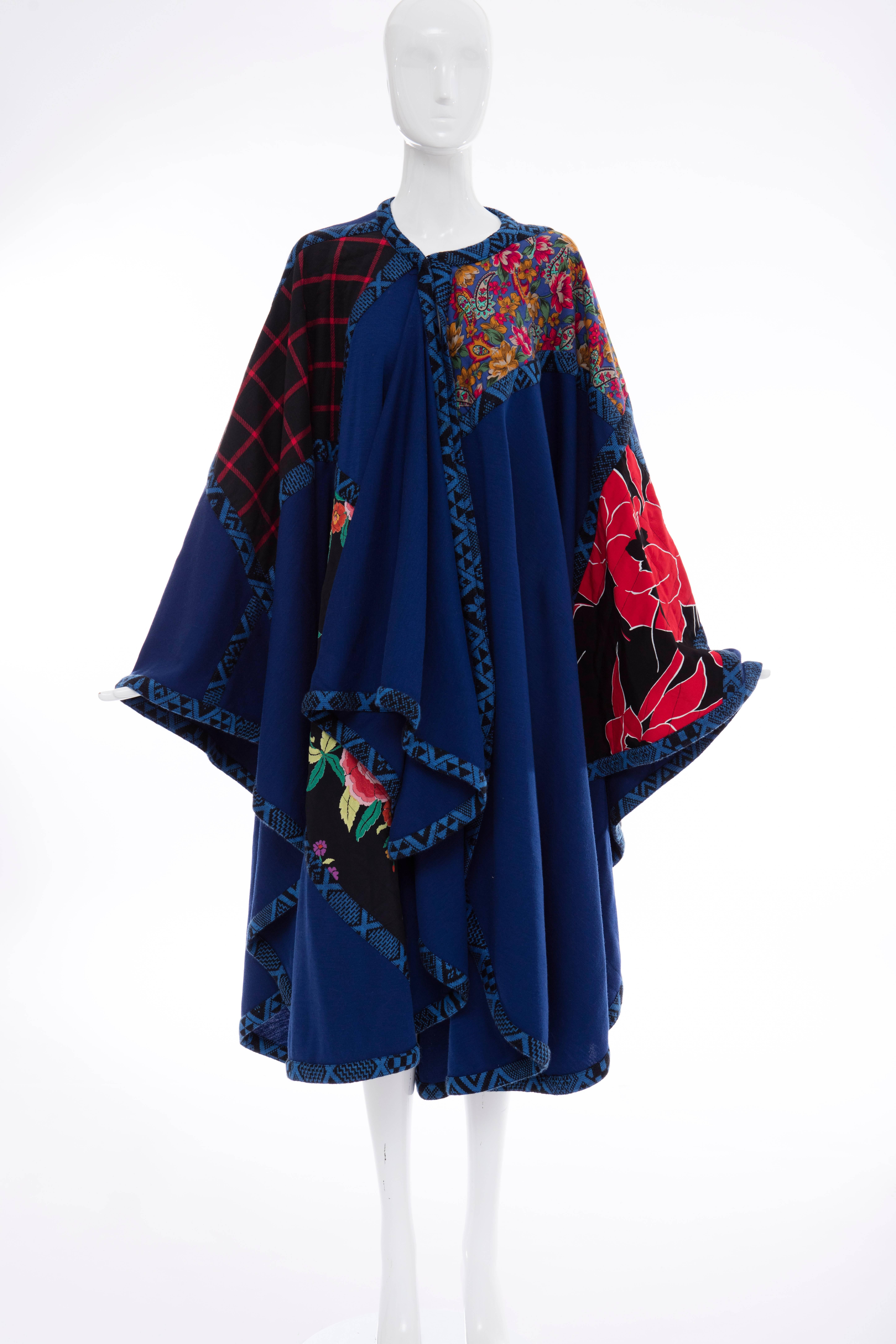 Koos Van Den Akker, circa 1980's royal blue cloak with floral and check quilted patchwork, graphic knit trim with hook-and-eye front closure.

One Size