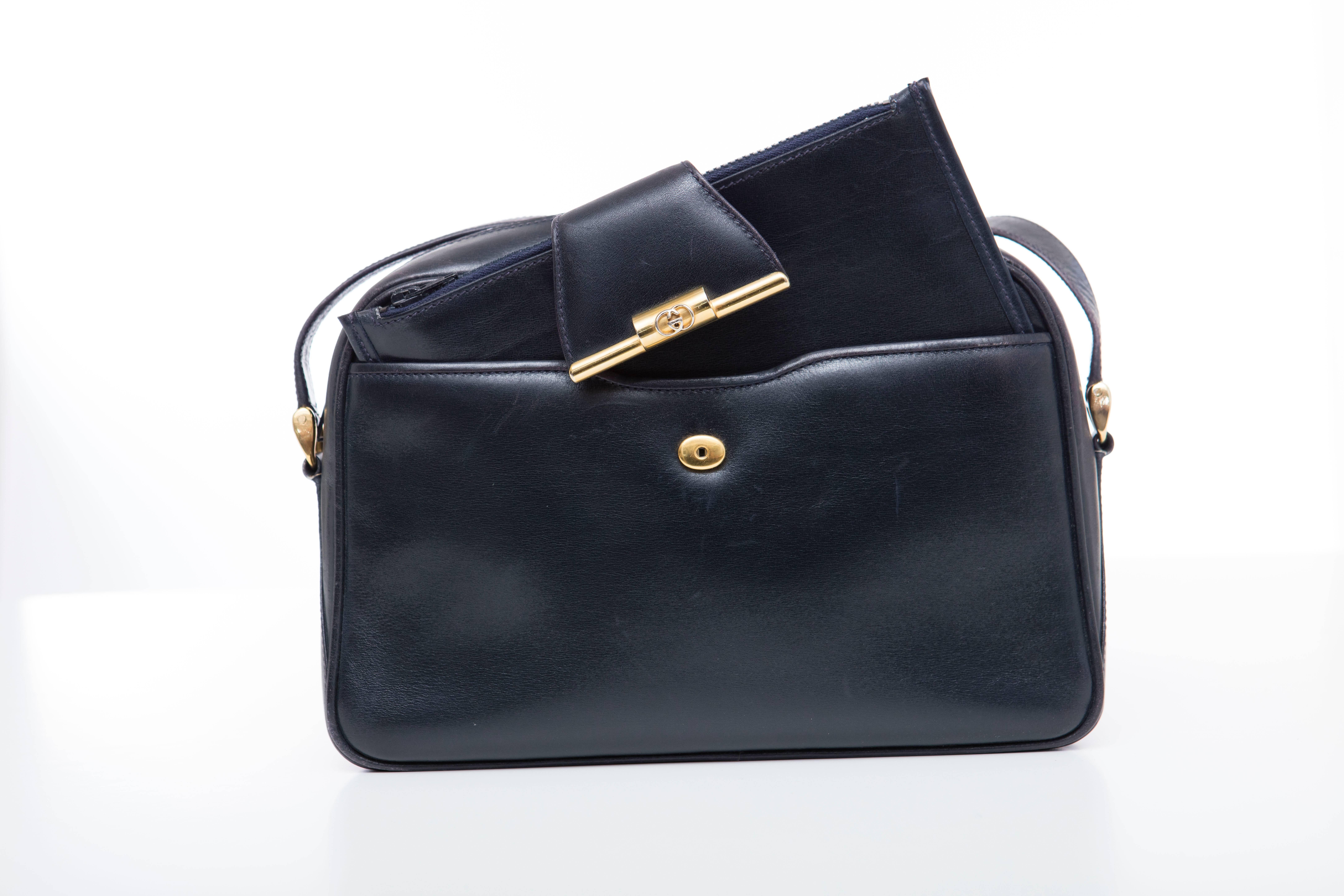 Gucci, circa 1970's navy blue leather cross body bag with snap front detachable wallet, YKK zipper, interior zip pocket.

Serial Number 46-01-4160 