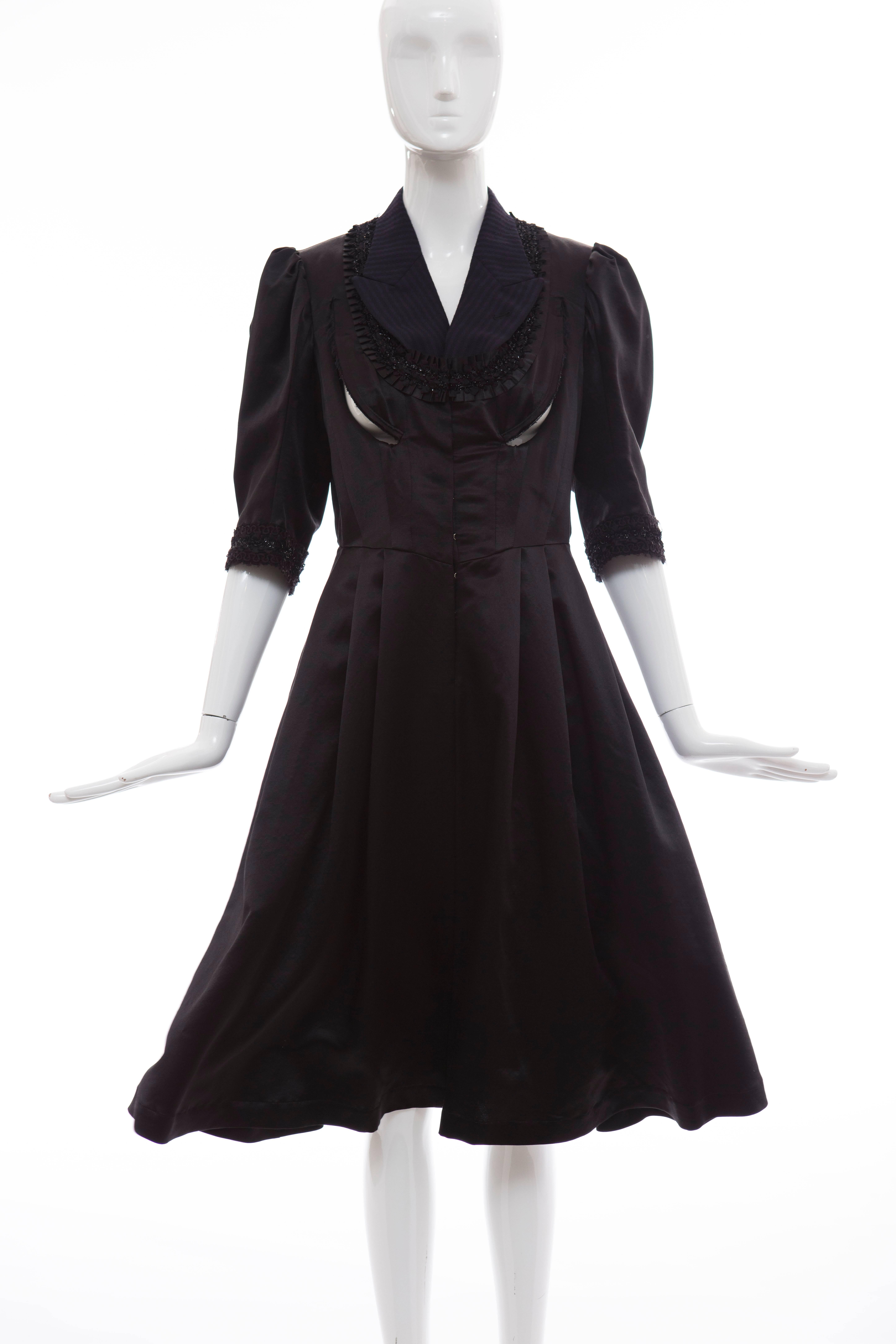 Comme des Garçons, Fall 2006 navy black midi wool silk satin dress with peak lapels, three-quarter length sleeves, embroidered and ruffle trim at neckline and sleeve cuffs, dual pockets at sides and hook closures at front.

Japan: Small

Bust 34