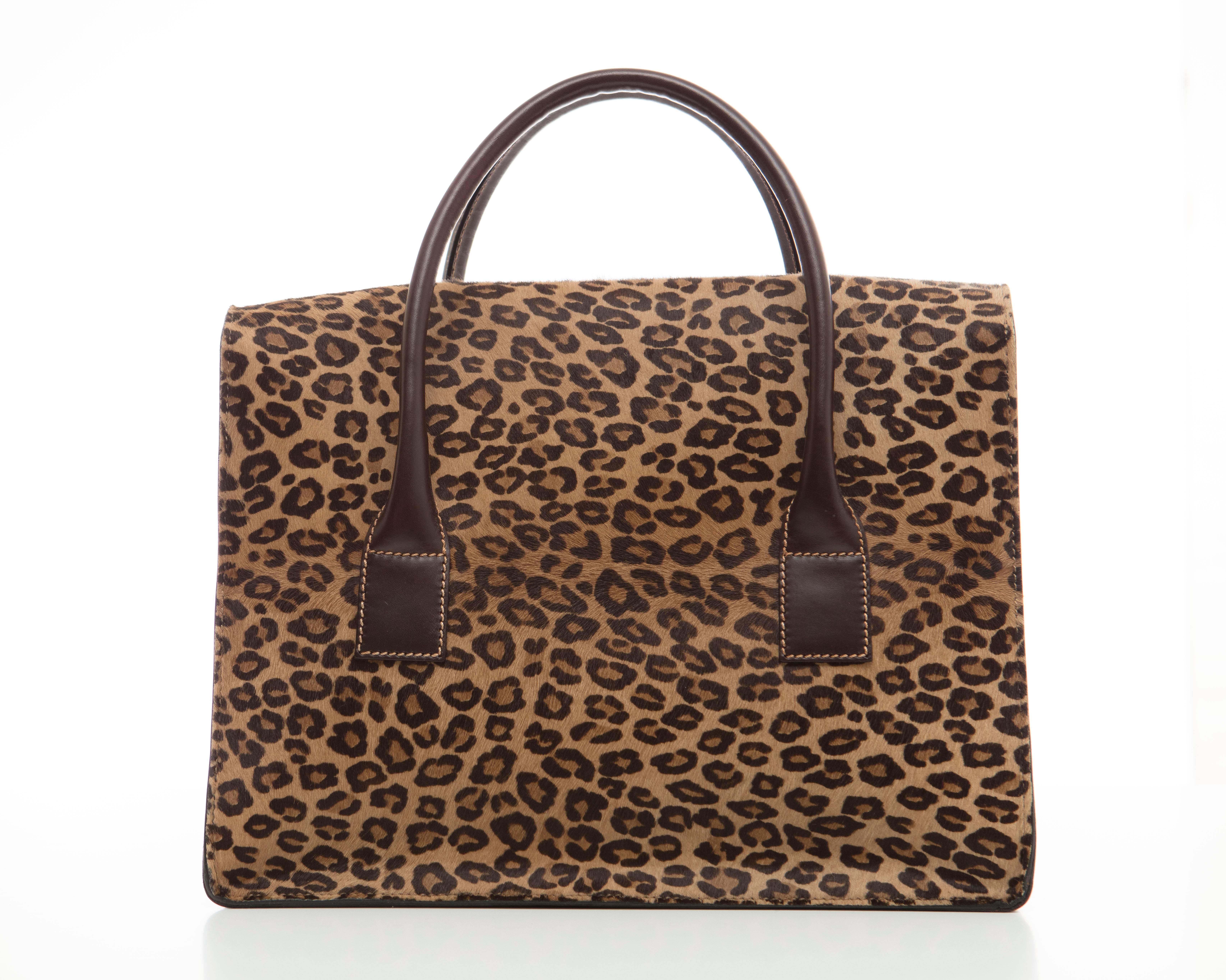 Lambertson Truex, circa 2006 leopard print pony hair top handle bag with gold-tone hardware, brown leather trim, dual rolled handles, brown suede interior, dual pockets at interior walls; one with zip closure and flap with flip-lock closure at