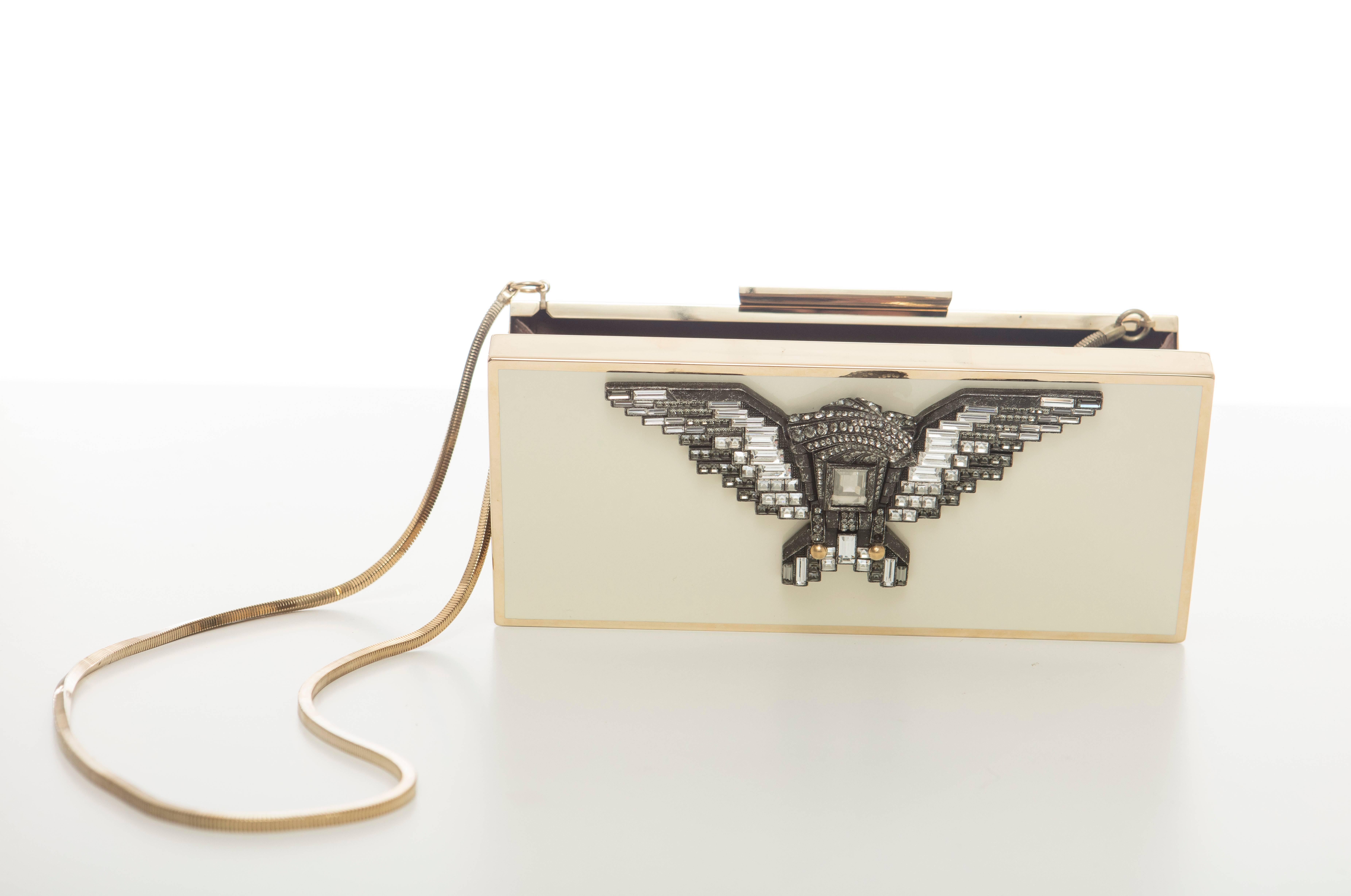 Alber Elbaz for Lanvin, Spring-Summer 2012 cream acrylic clutch with gold-tone hardware, single drop-in shoulder strap with chain-link accent, gunmetal and clear swarovski crystal embellished eagle at front face, brown satin lining and magnetic